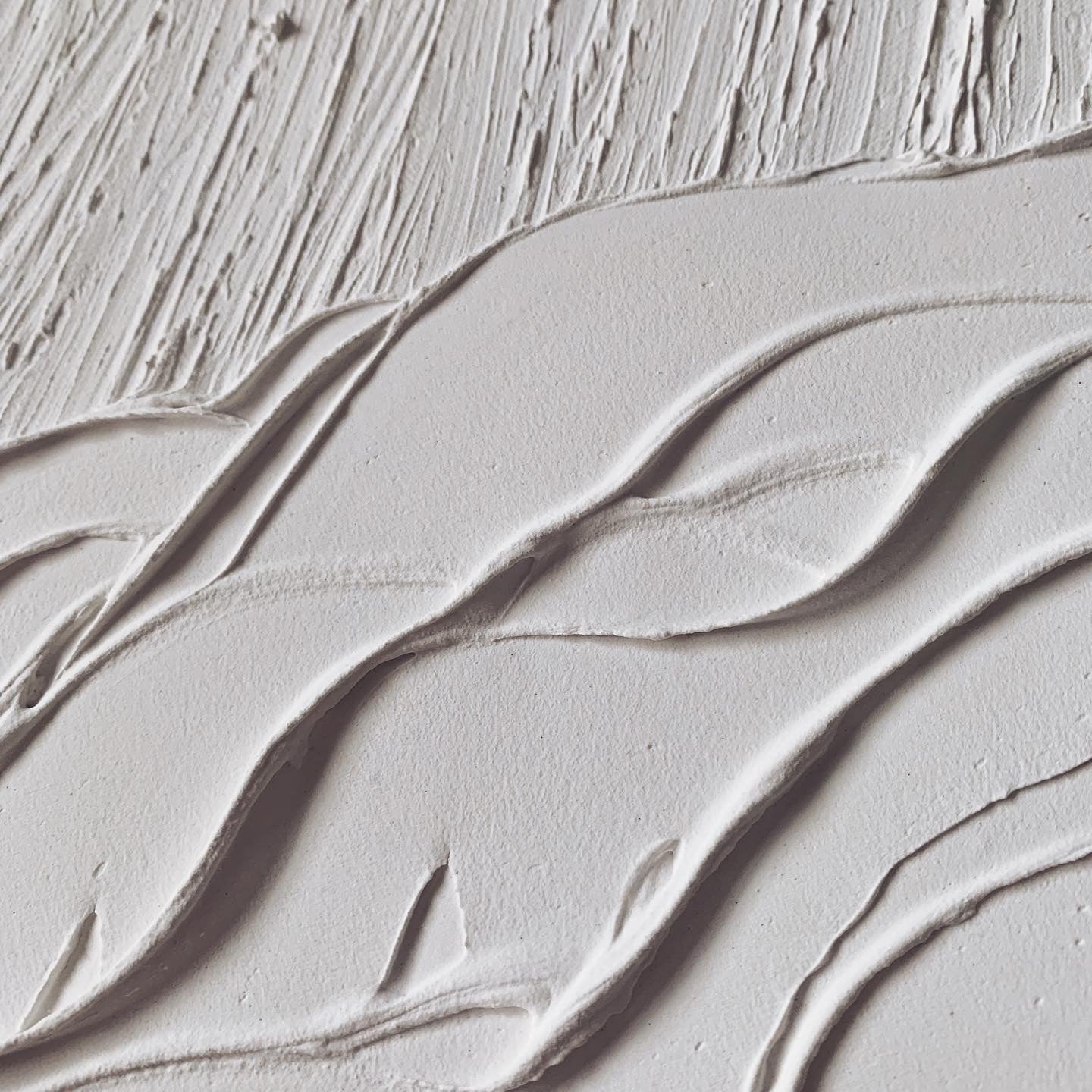 Close-up of white AVALANCHE artwork showing texture and depth