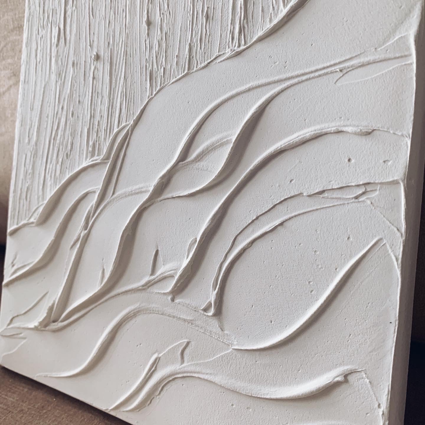 Close-up of white AVALANCHE artwork showing texture and depth