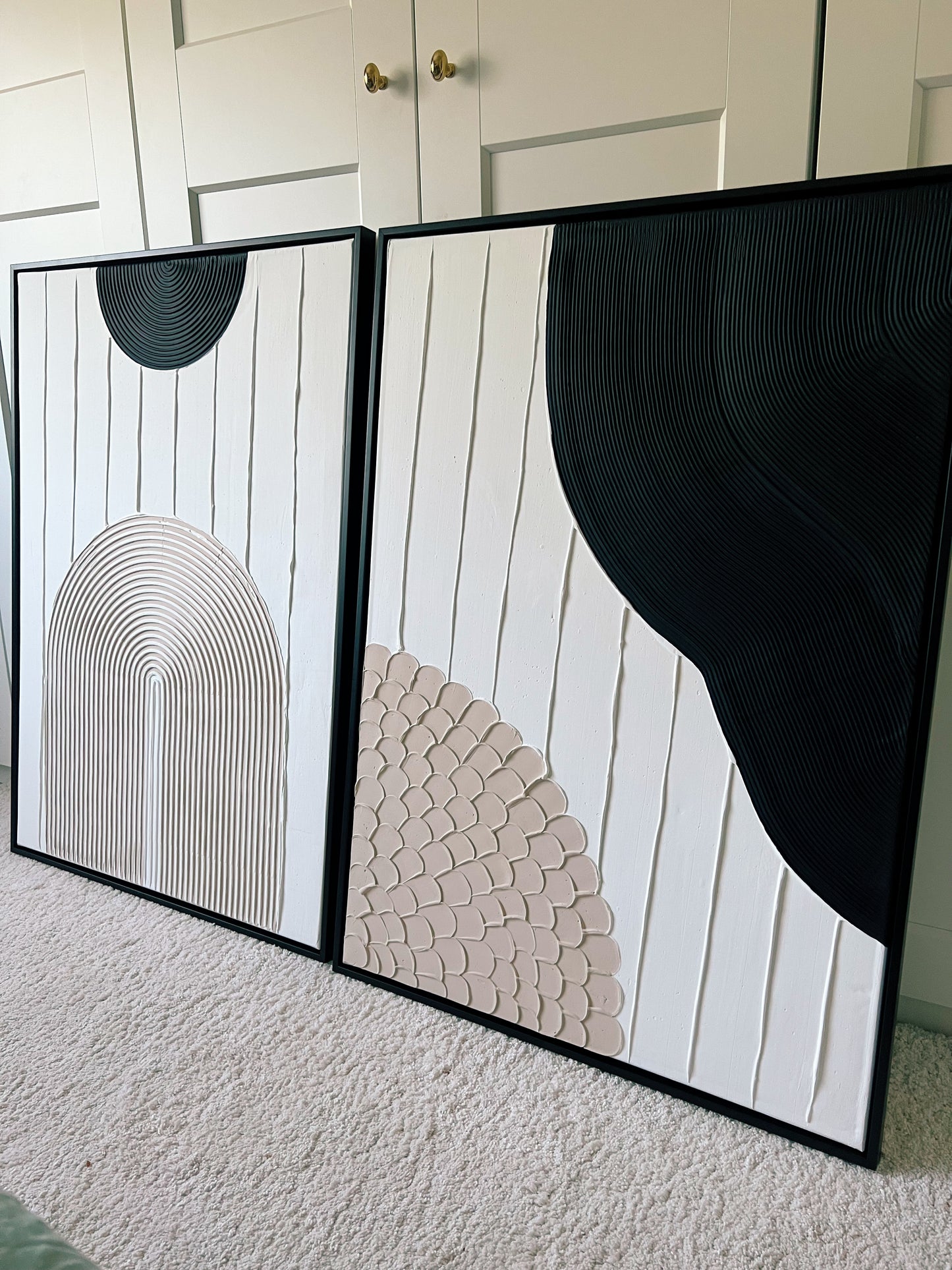 Two abstract art pieces with geometric designs on a textured surface.