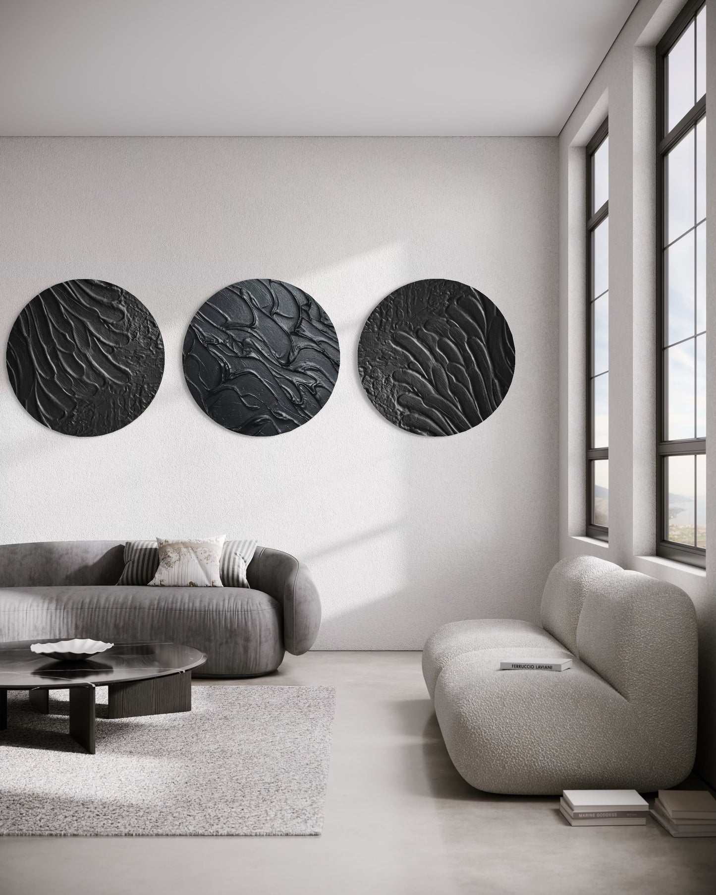 Modern living room with three black circular wall art pieces on a white wall.