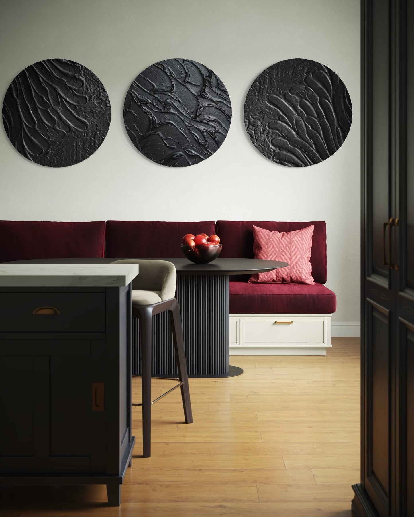 Modern interior with a red bench, round black wall art, and a small table with fruit.
