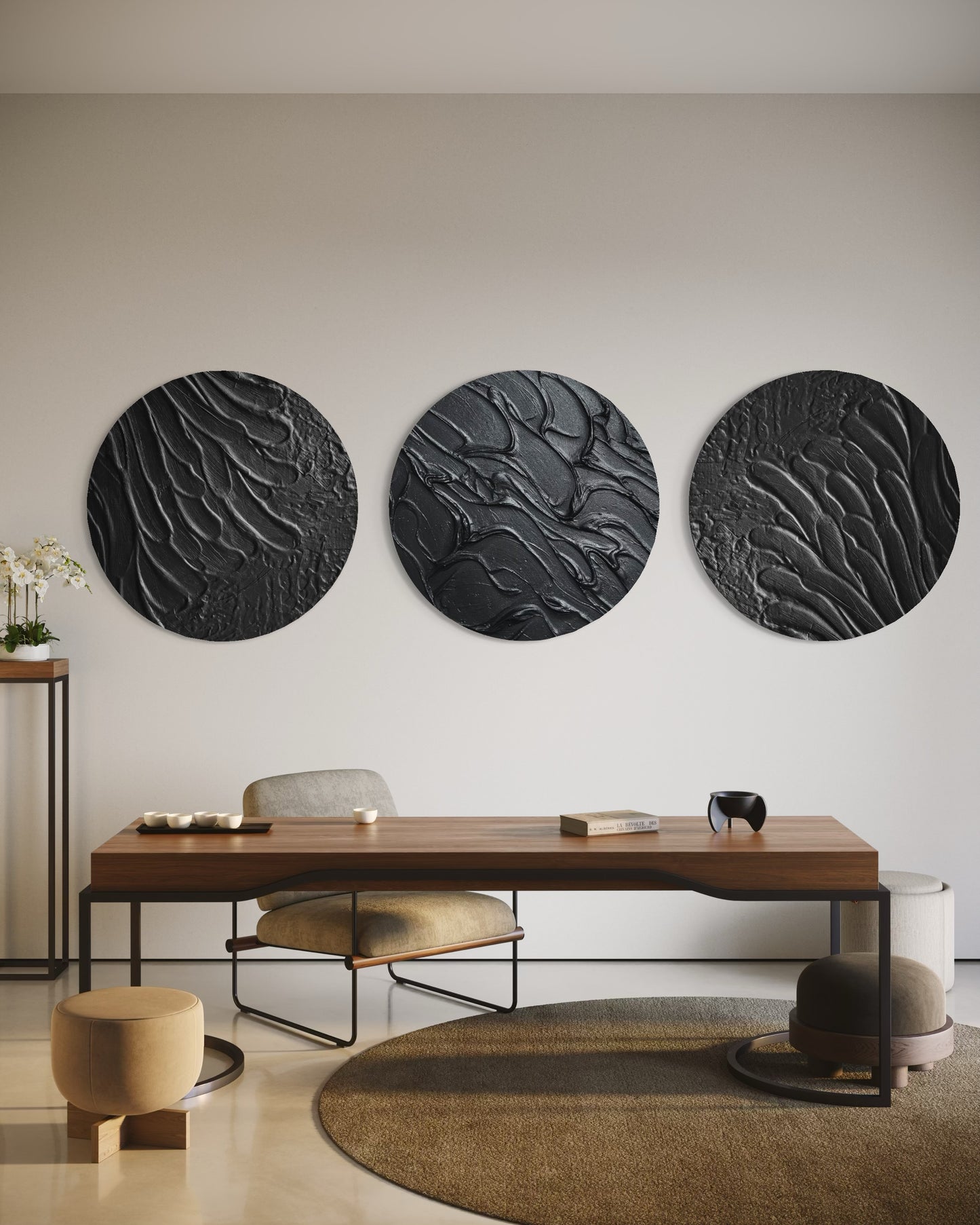 Three circular black wall art pieces above a wooden desk in a modern office setting.