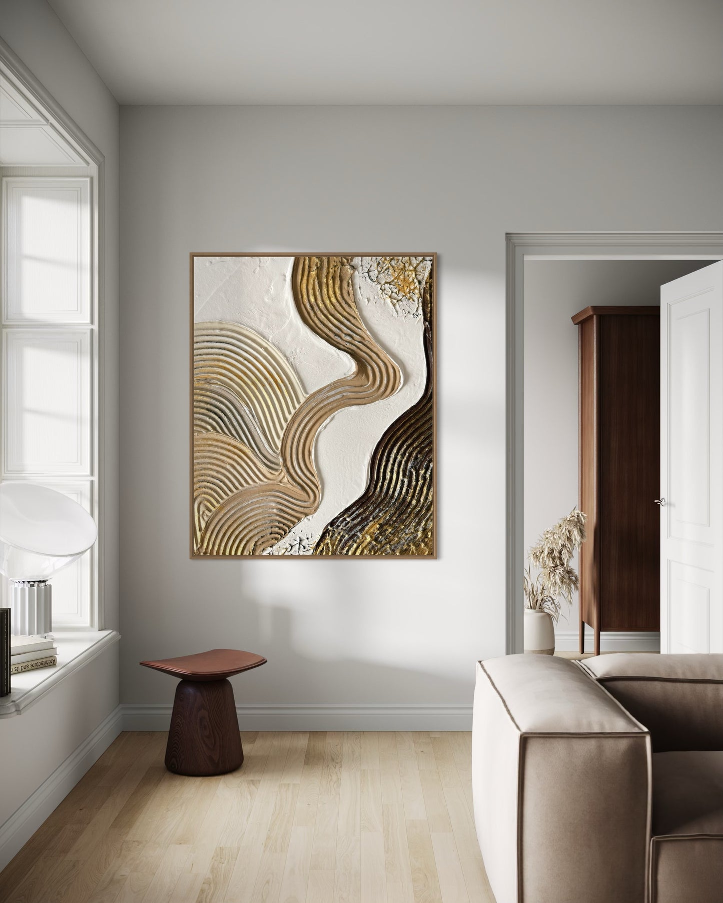 Modern interior with abstract art on a wall, a chair, and a sofa.