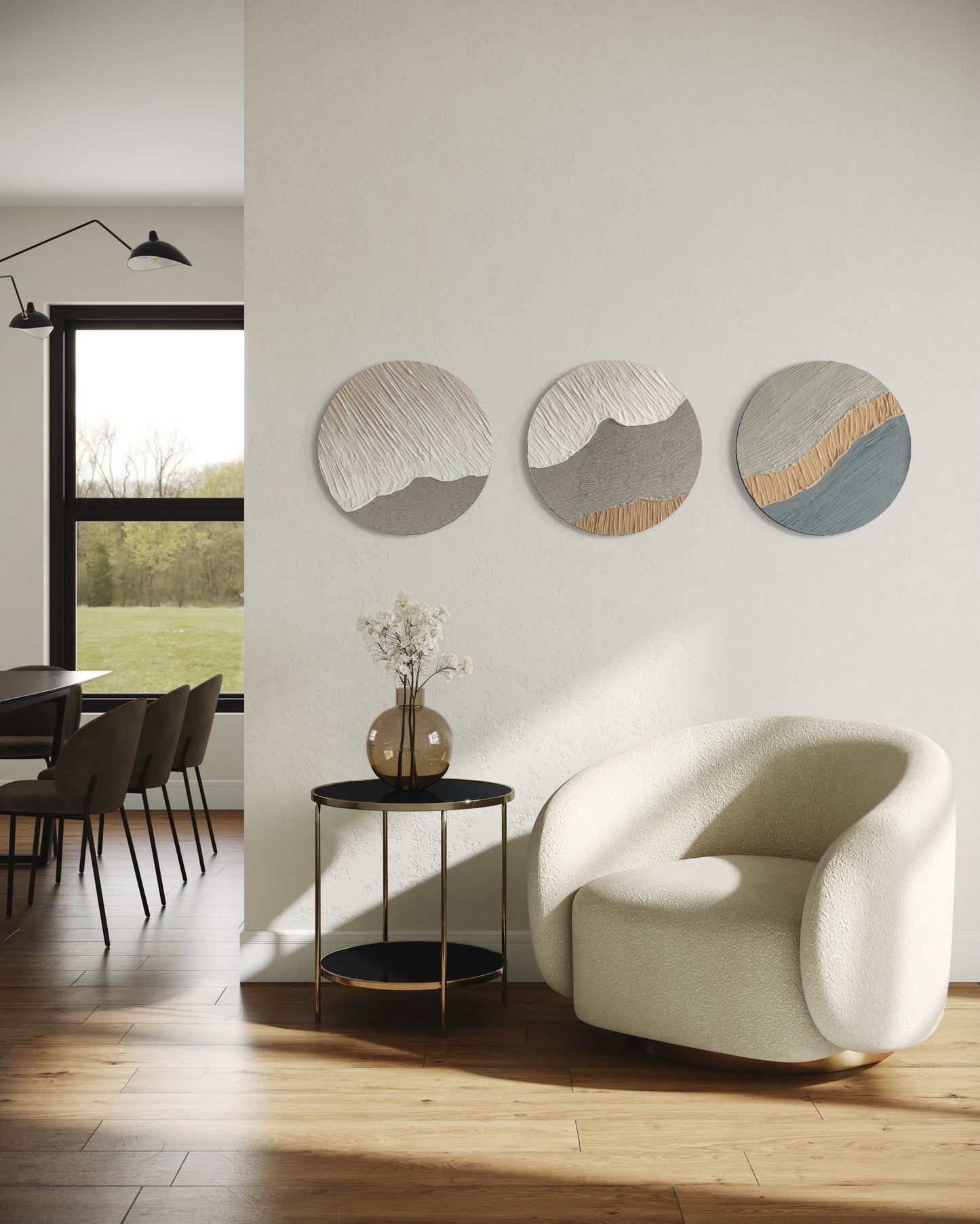Modern living room with a white armchair, round side table, and wall art.