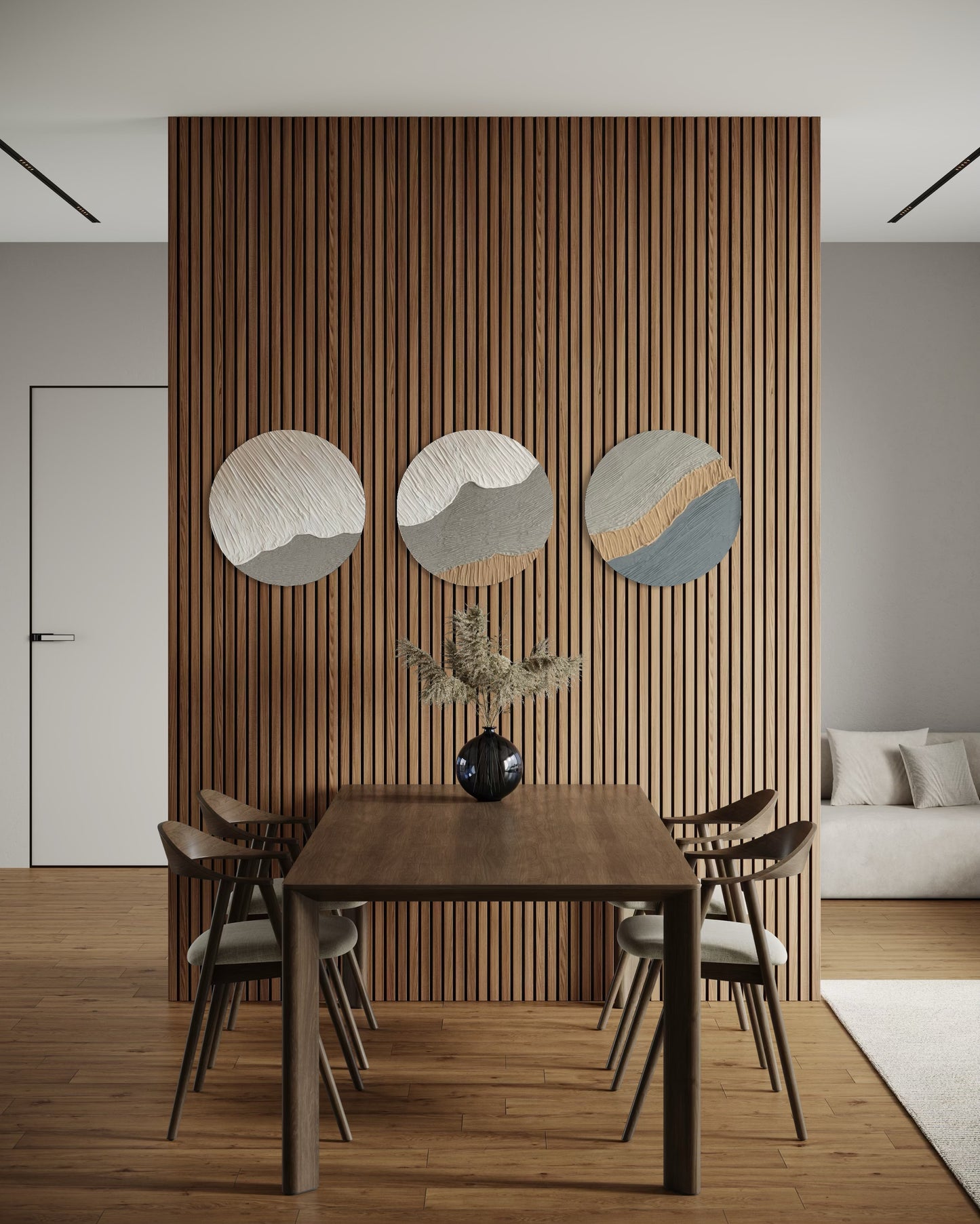 Dining area with wooden table and chairs against a slatted wood wall with circular decorations.