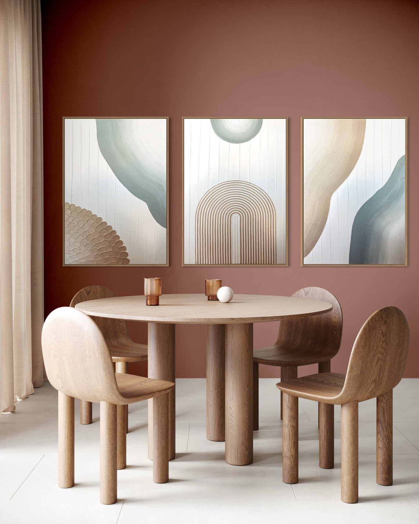 Dining area with a round wooden table and chairs against a pink wall with abstract art.