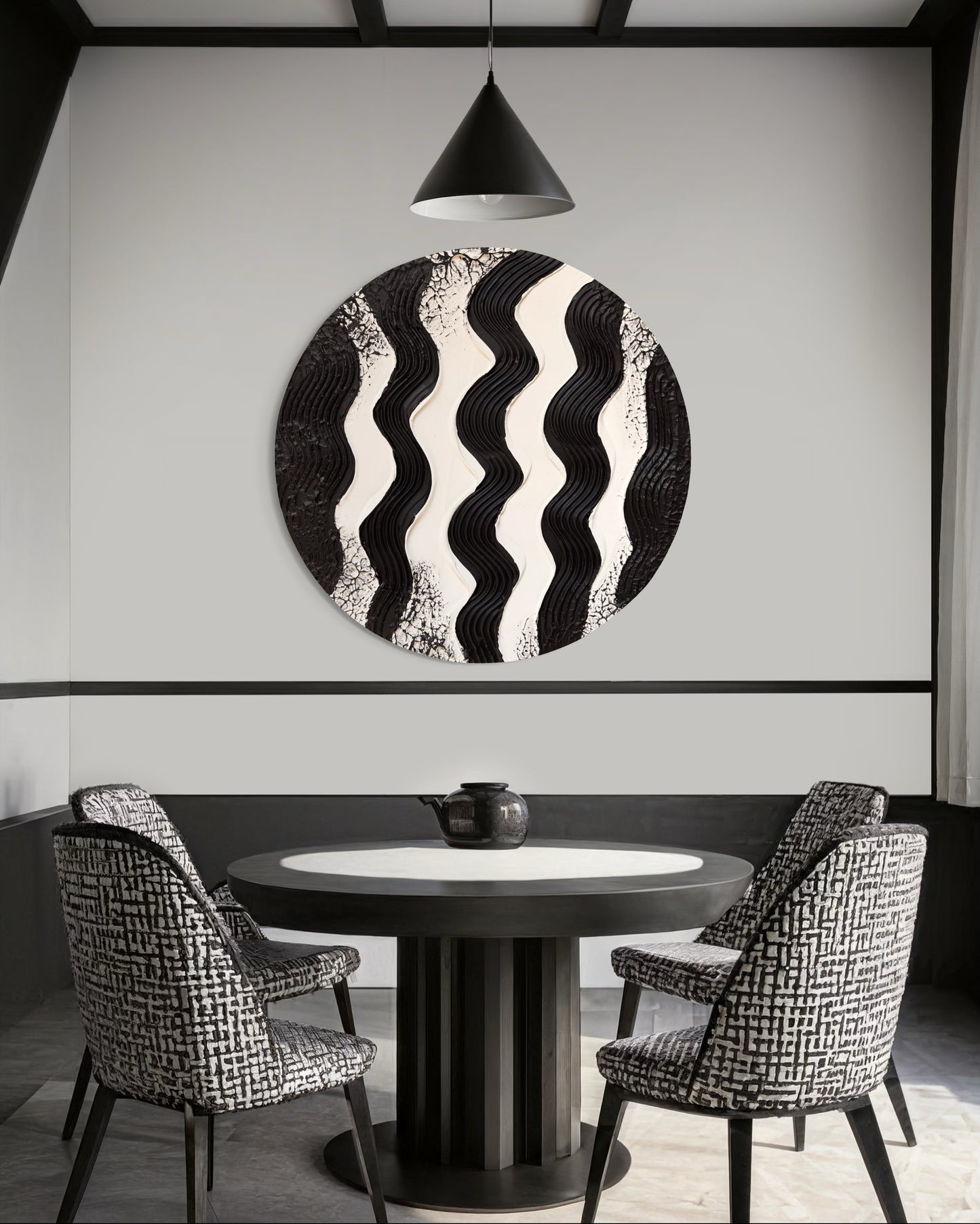 Dining room with a round table and chairs, featuring a decorative wall piece.