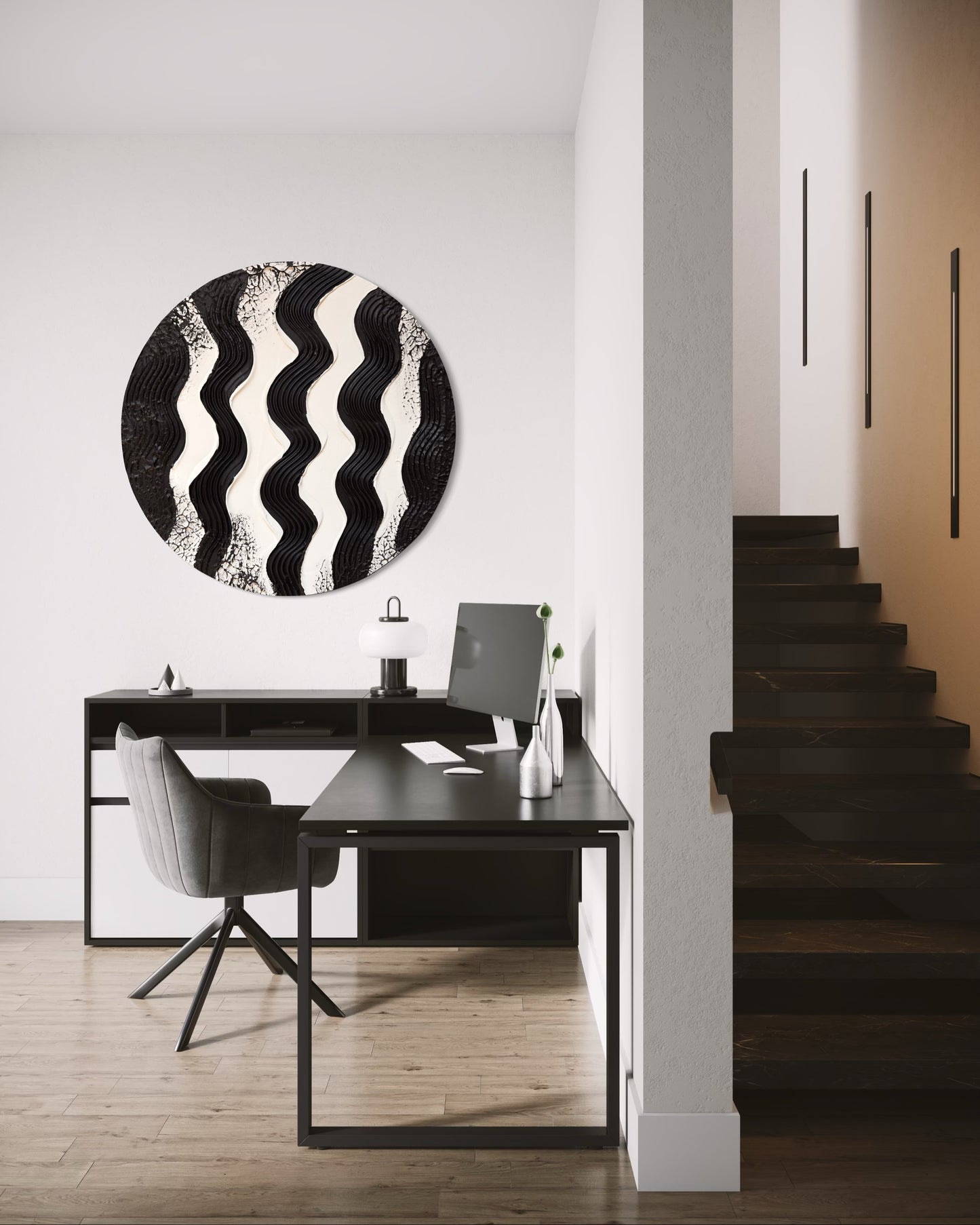 Modern interior with a black and white abstract wall art piece above a desk.