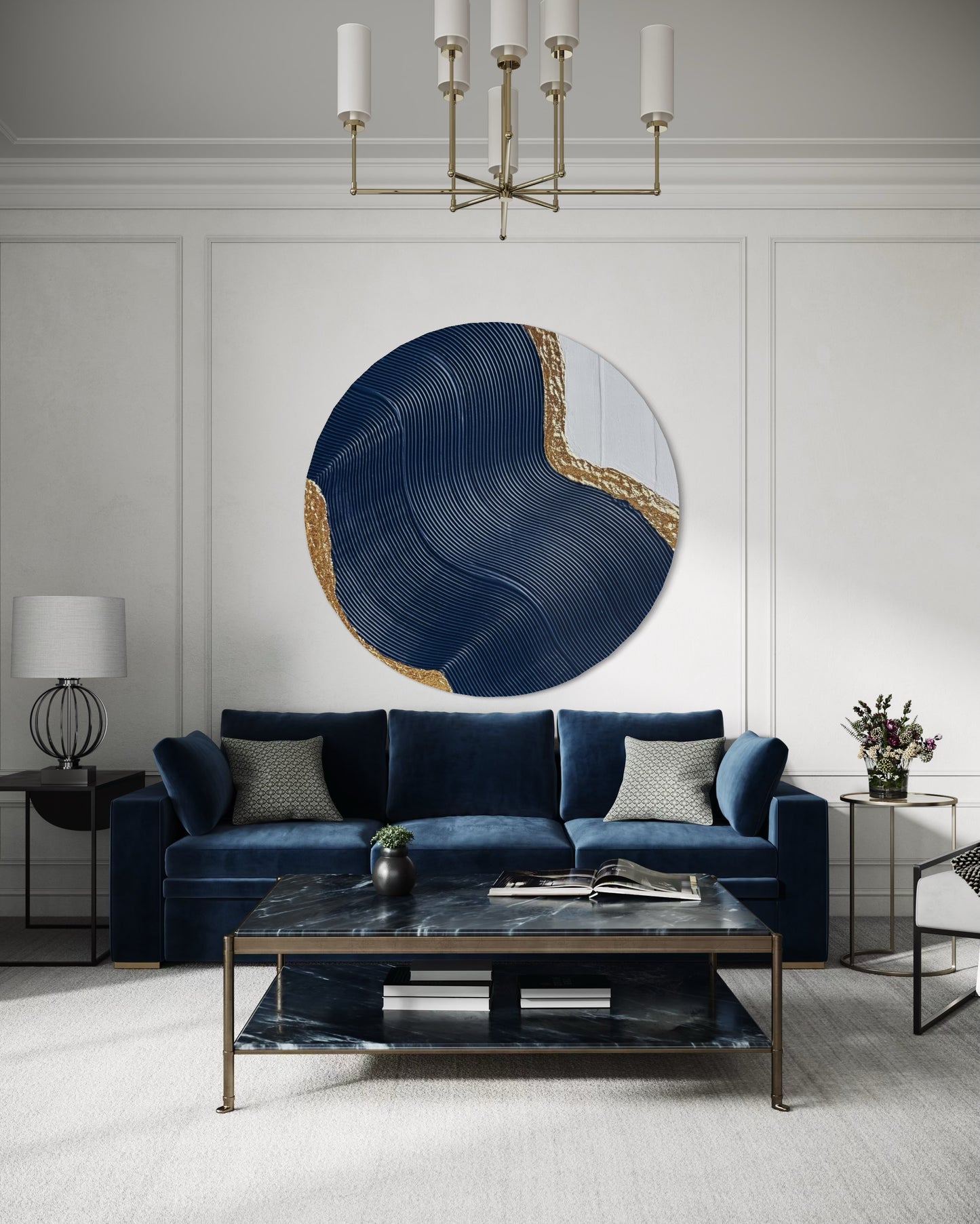 Modern living room with a blue sofa, round abstract wall art in navy blue and gold, and a chandelier.