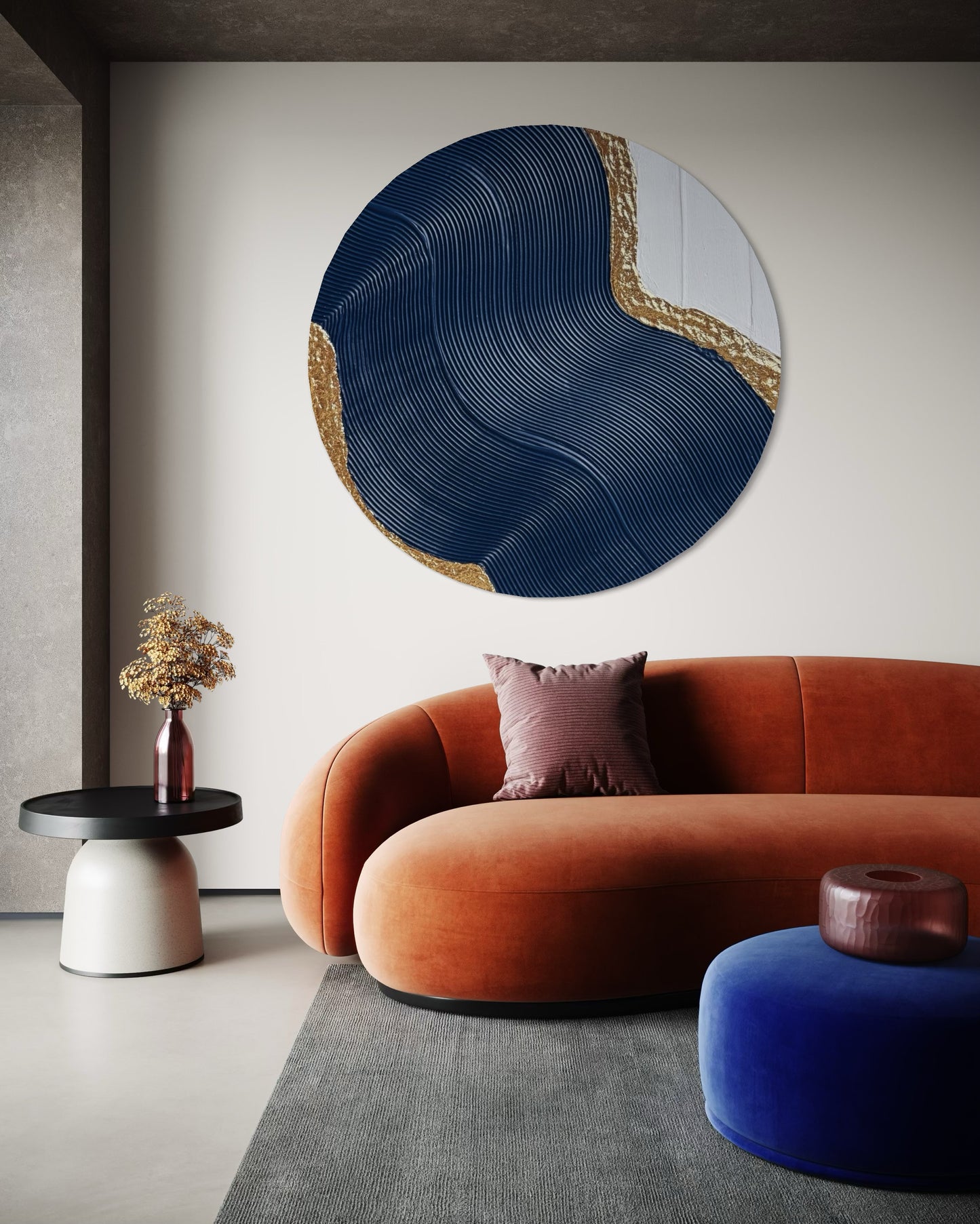 Modern interior with a round abstract wall art piece, orange sofa, and blue pouf.
