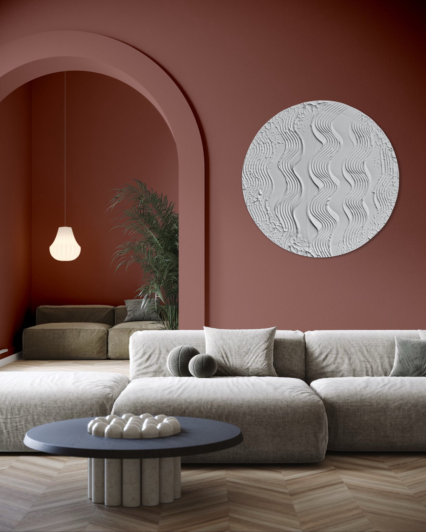 Modern living room with a gray sectional sofa, round coffee table, and decorative textured 3D minimalist wall art.