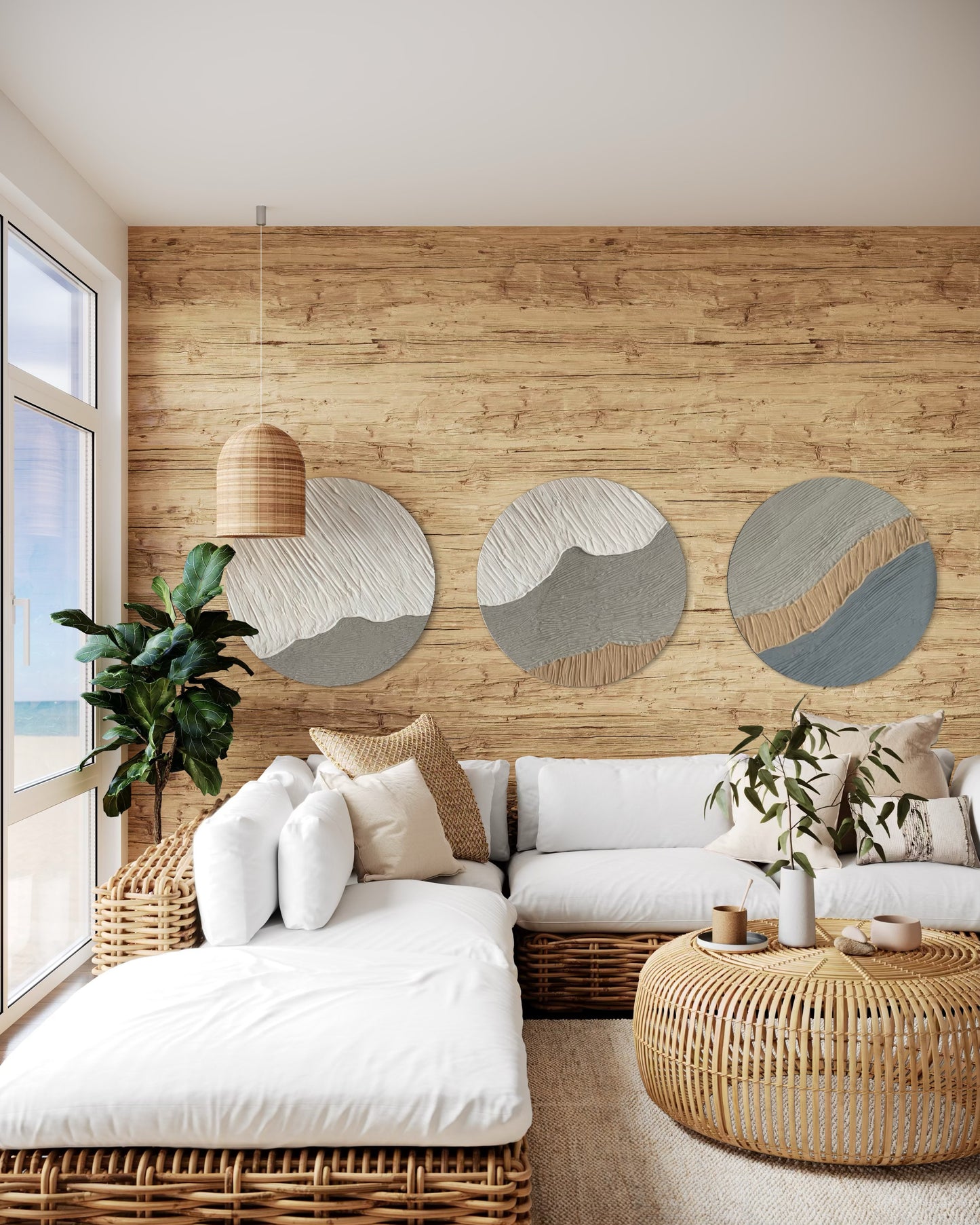 Cozy living room with wooden wall, white sofa, and wicker furniture. On the wall set of 3 round textured wall art.