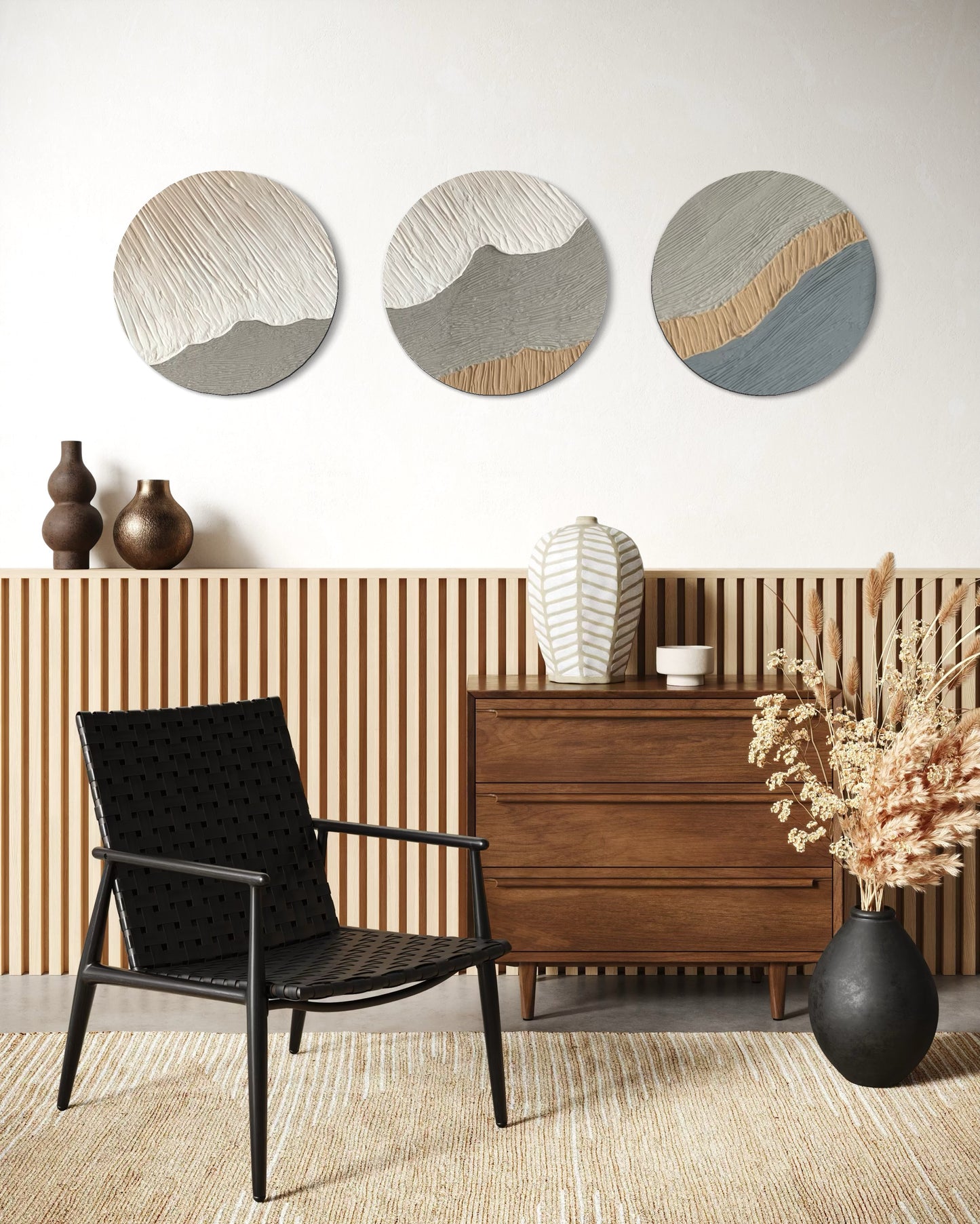 Modern interior with a black chair, wooden dresser, and decorative wall art.