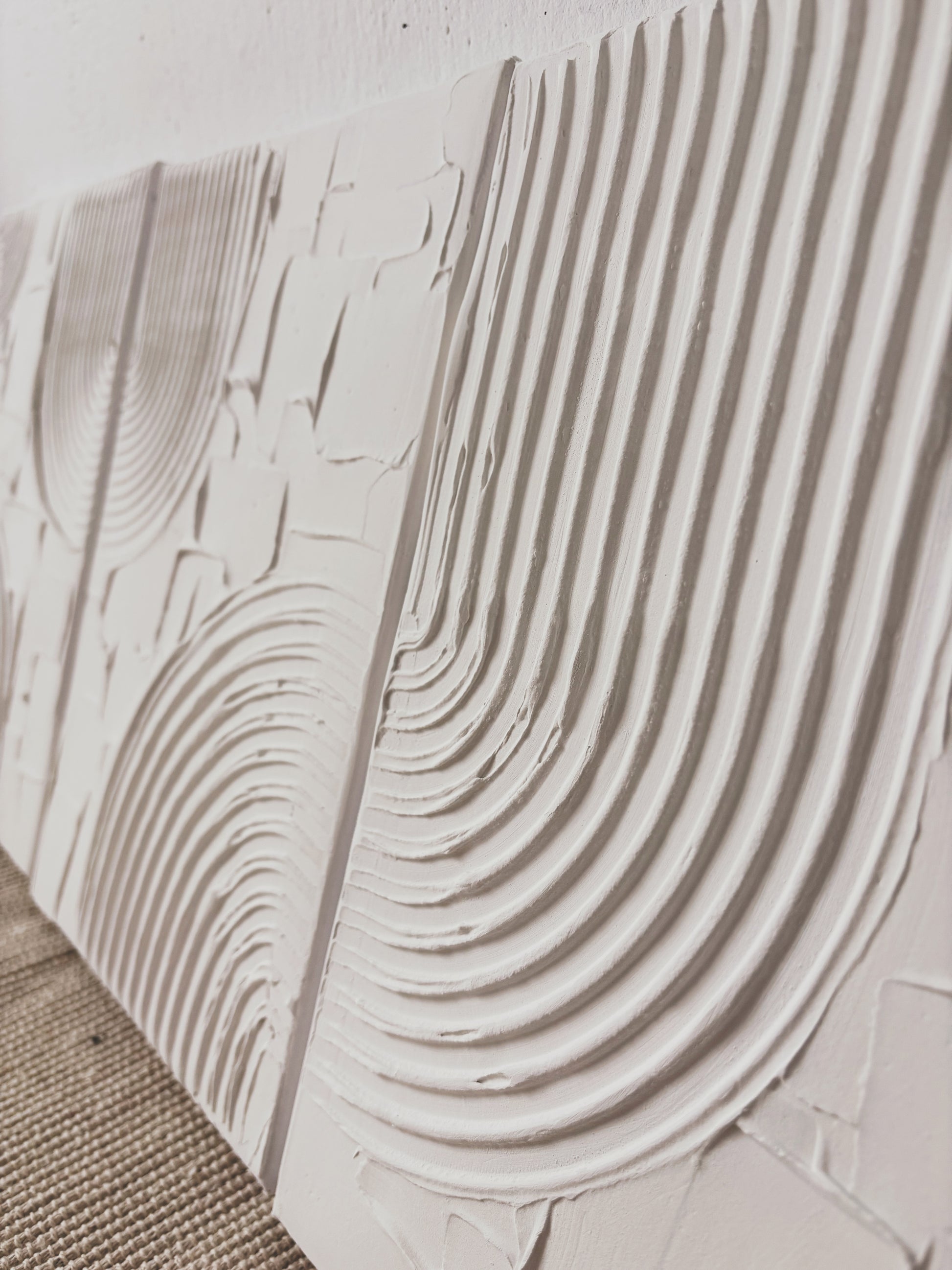 Close-up of textured wall art surface with wavy patterns