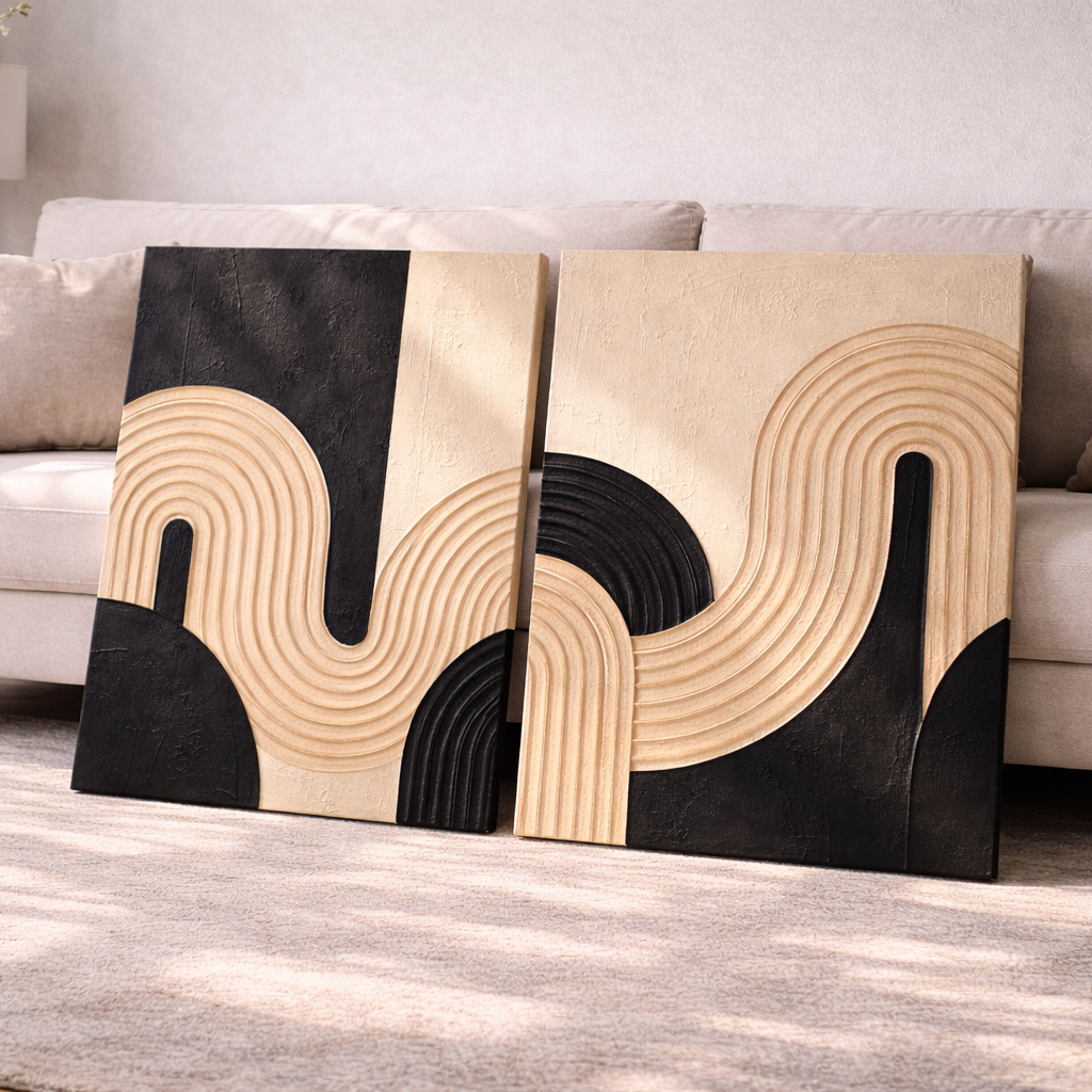 Two textured abstract wall art pieces on a sofa in a living room setting.