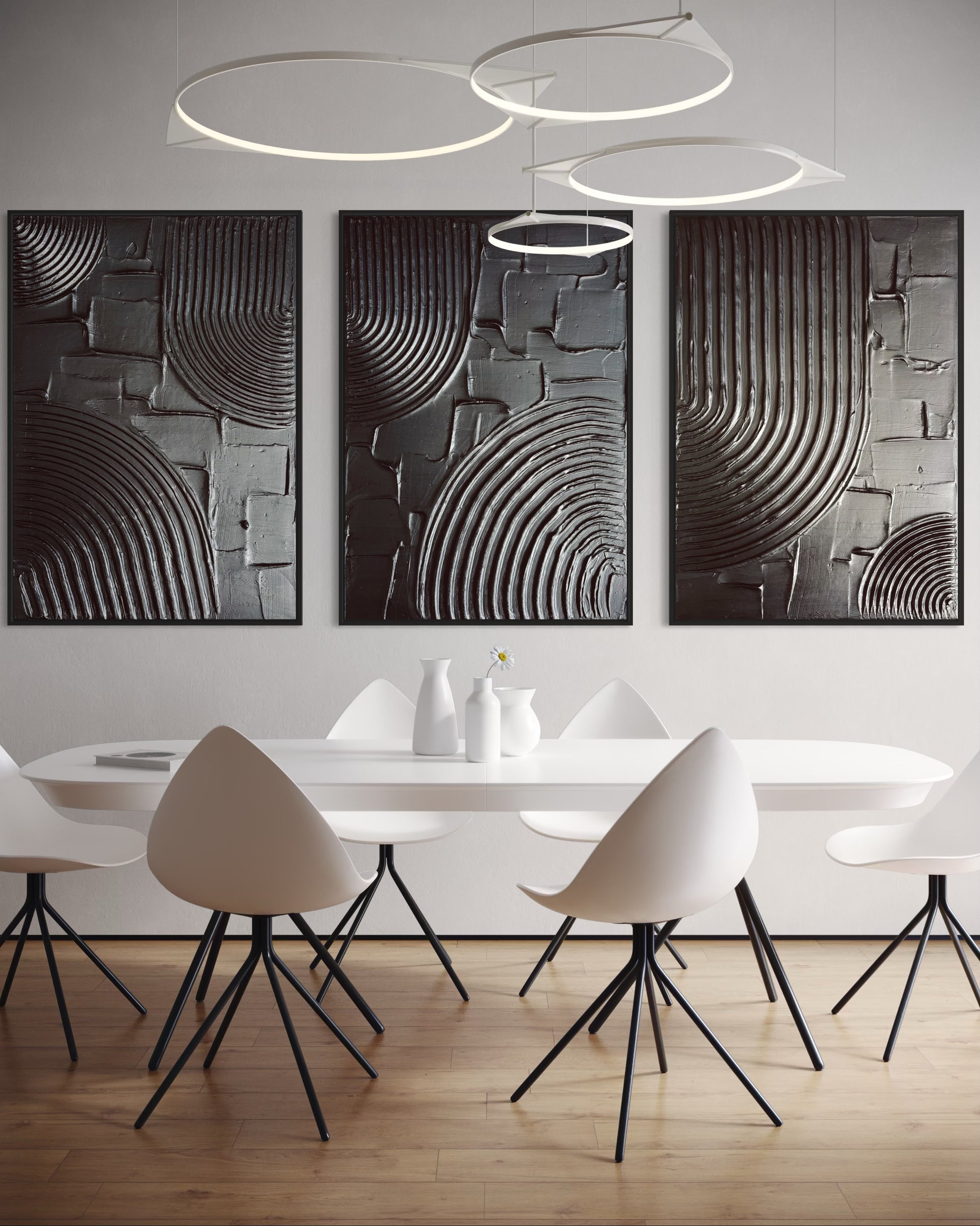 Modern dining room with white table and chairs, abstract wall art, and pendant lights.