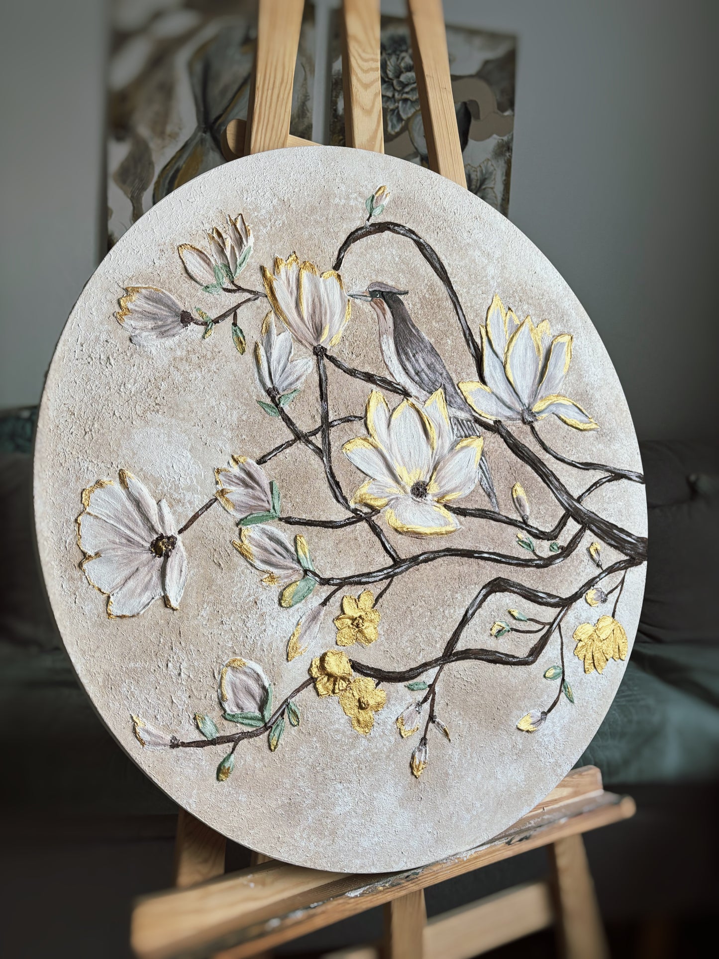 Painting of flowers and a bird on a round stone surface