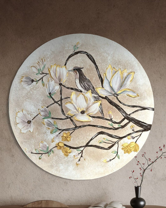 Decorative wall piece with birds and flowers on a beige wall above a wooden console table.