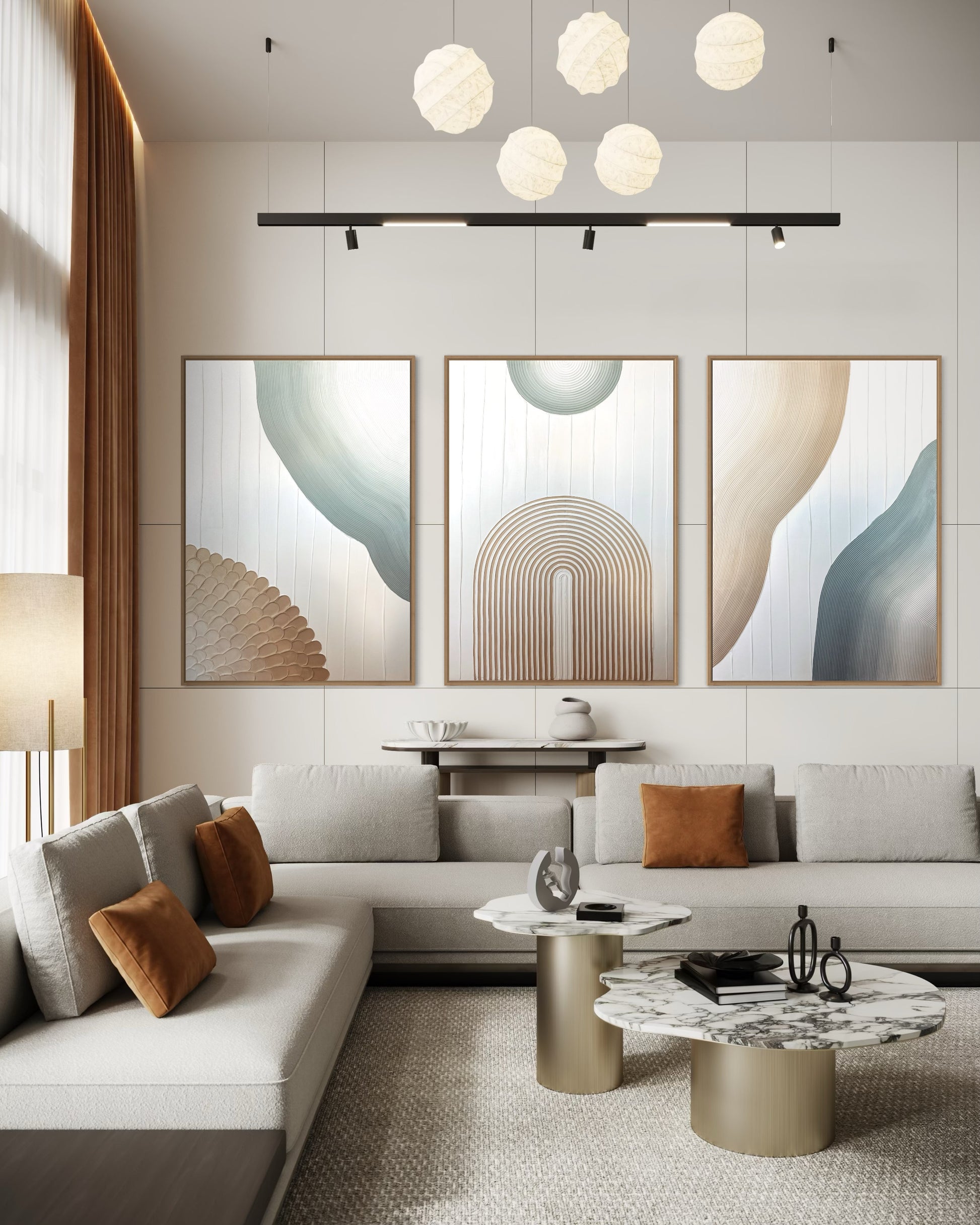 Modern living room with abstract textured set of 3 wall art, a sofa, and decorative items.