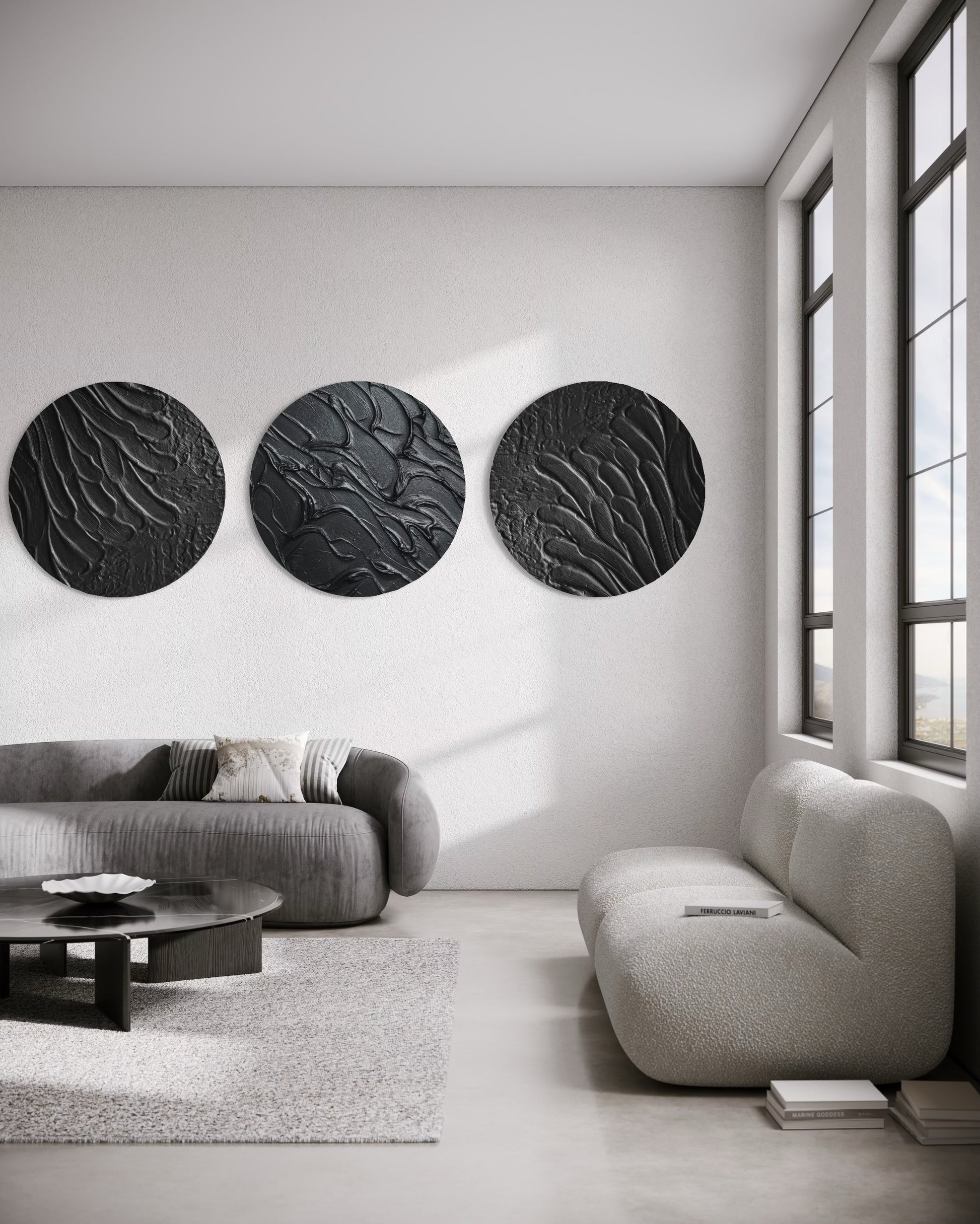 Modern living room with three black circular wall art pieces on a white wall.