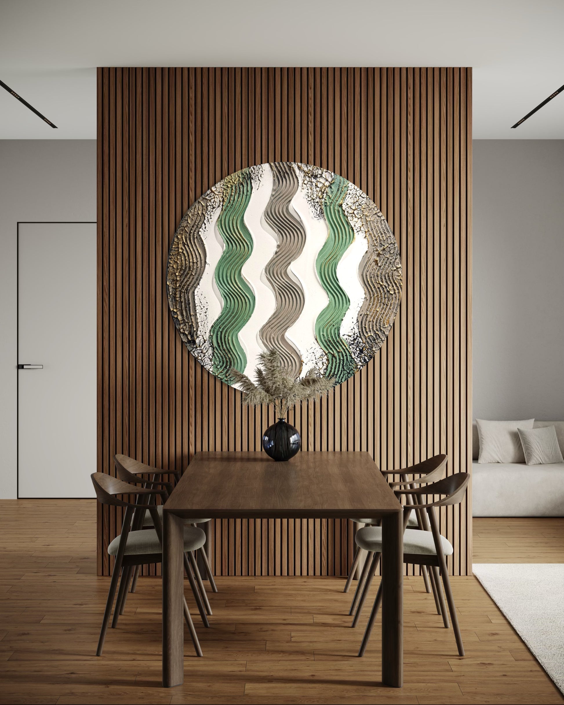 Dining room with a round minimalist modern wall piece and wooden table.
