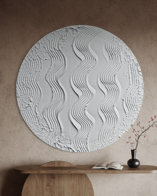 Round 3D white textured wall art piece in a room with wooden furniture and decor.