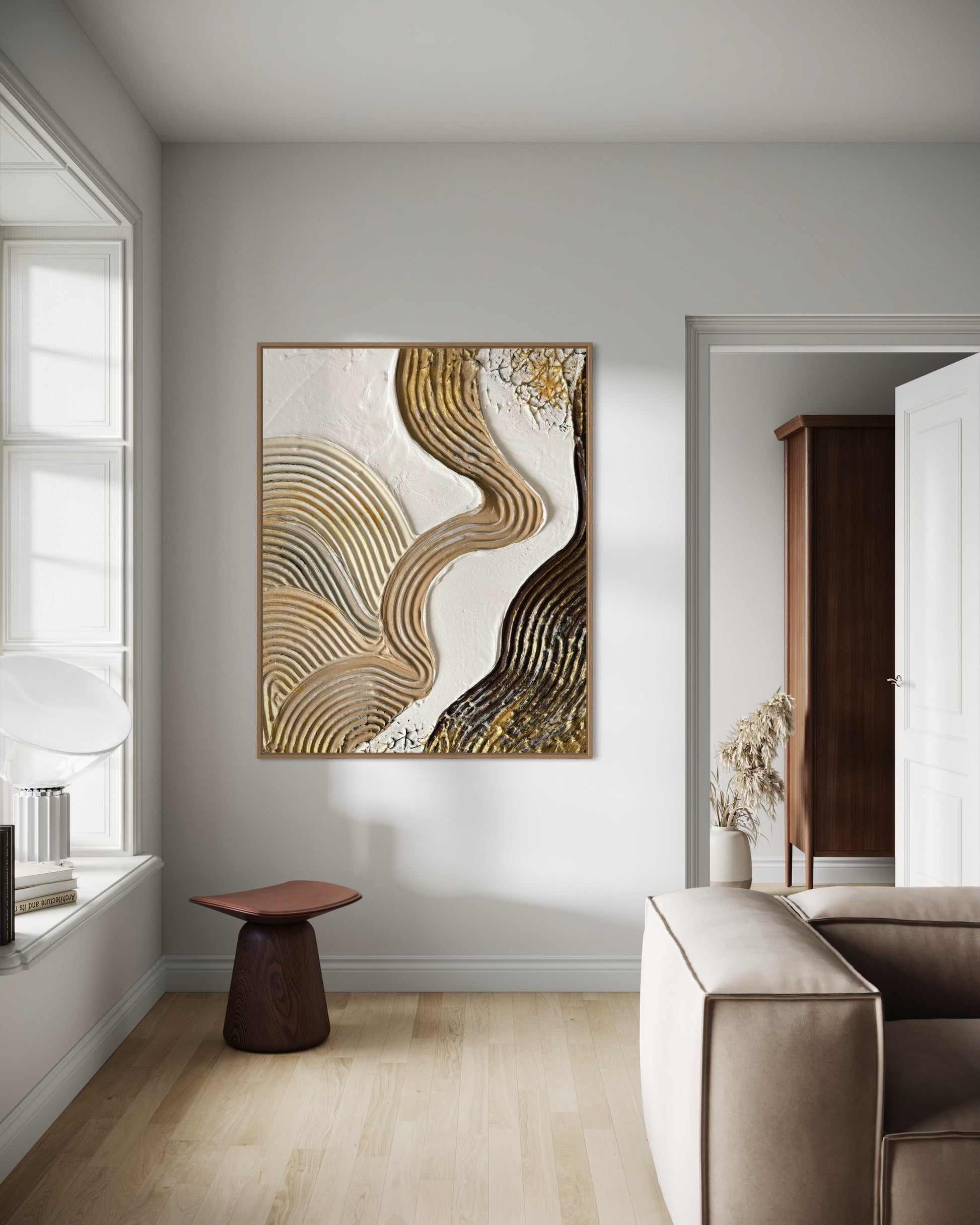 Modern interior with abstract art on a wall, a chair, and a sofa.