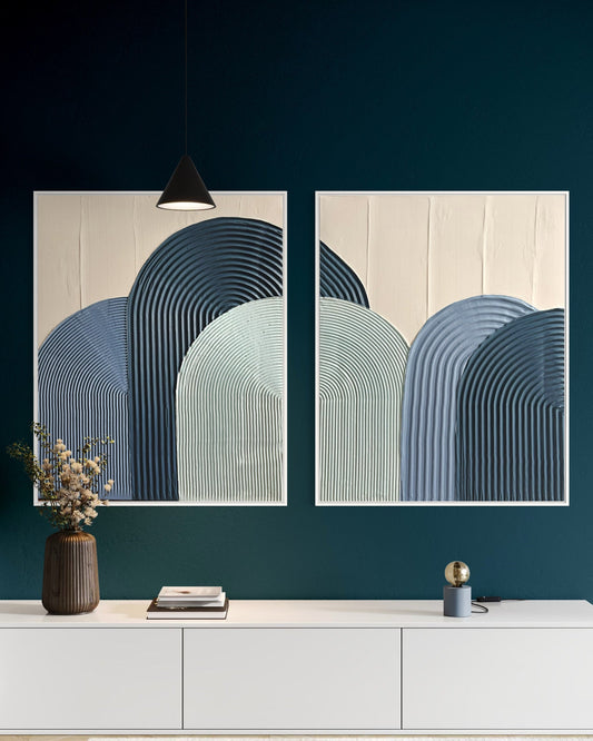 Modern interior with abstract textured wall art in blue and a white console table.