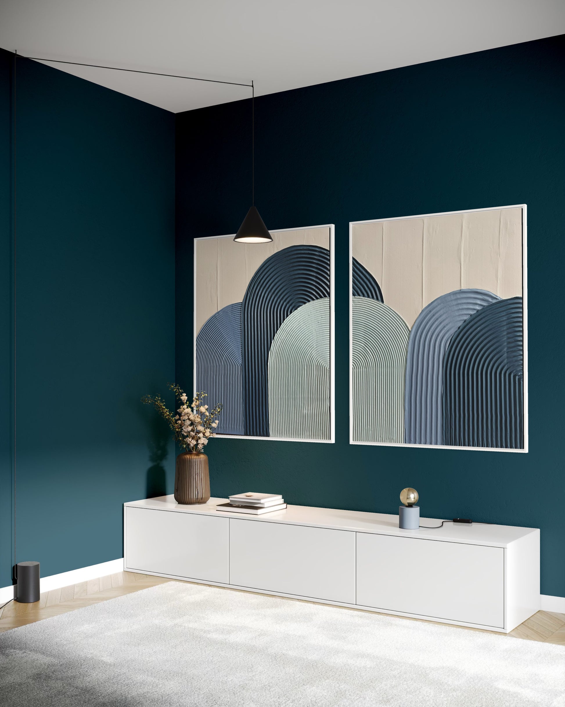 Modern interior with two abstract wall art pieces on a dark blue wall.