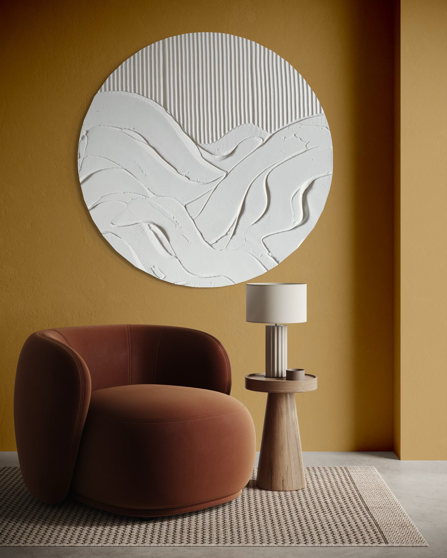 Round abstract wall art piece on a mustard yellow wall with a brown chair and wooden side table.