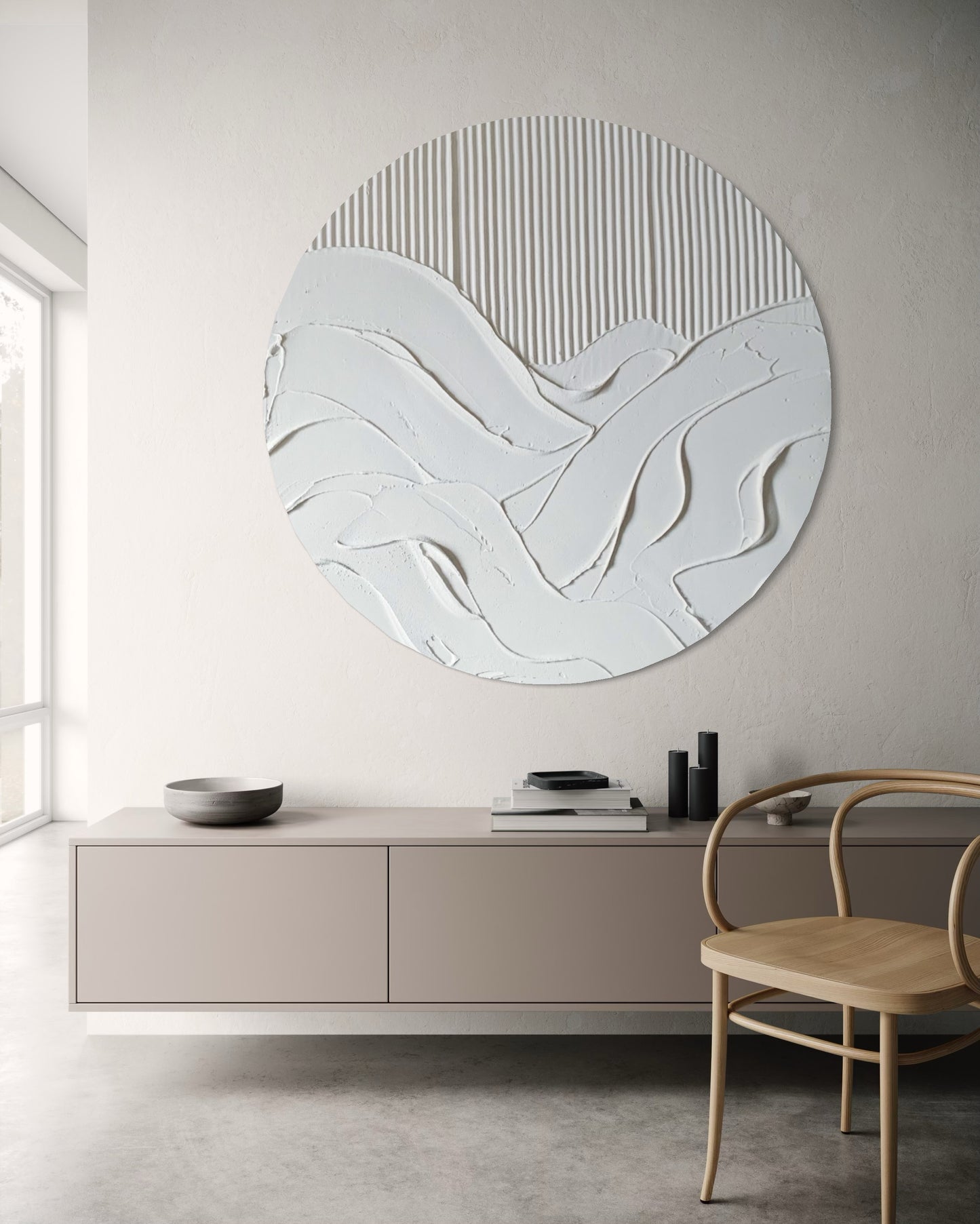 Round abstract wall art piece on a neutral wall with a modern interior setting.