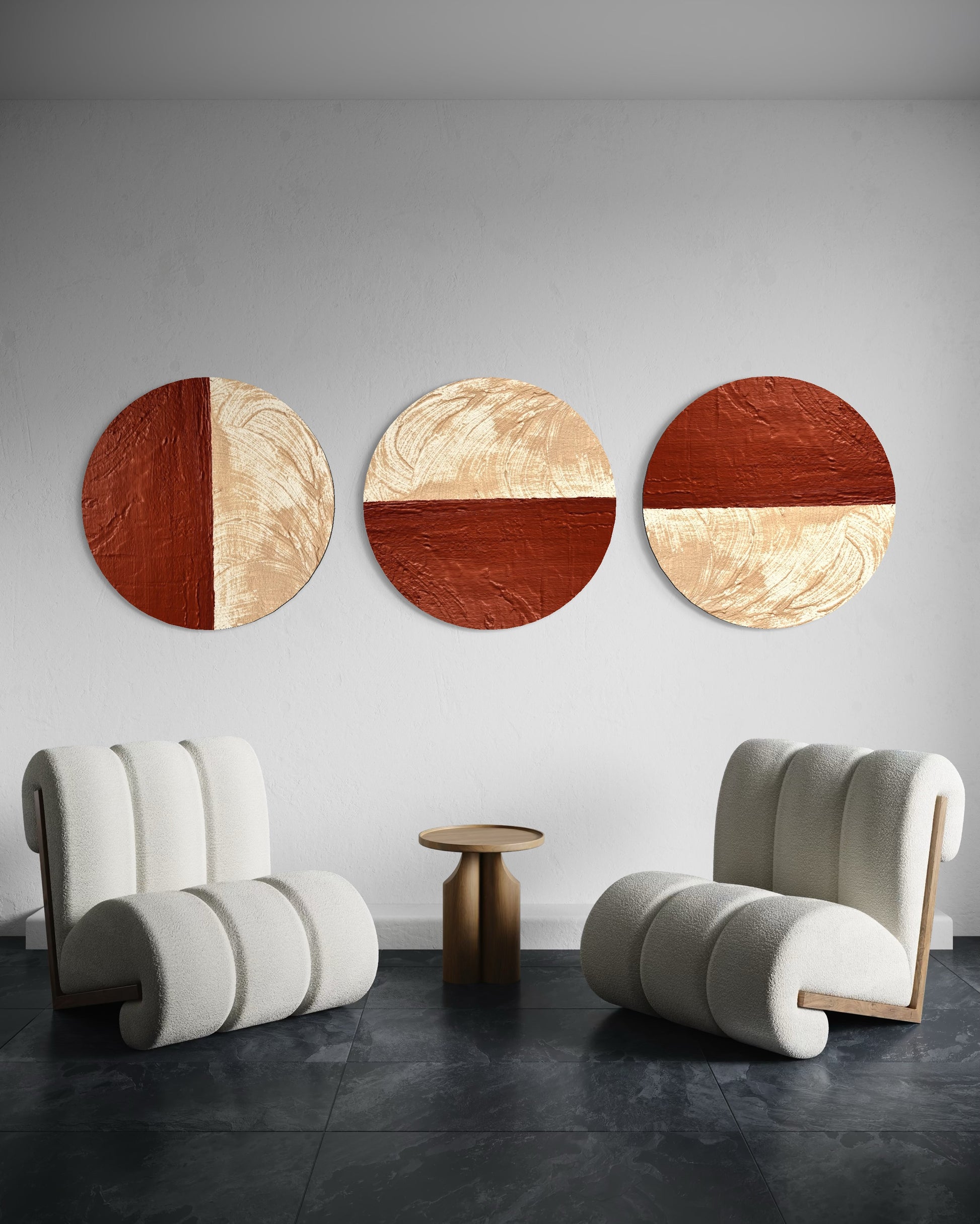 Three circular wall art pieces with wooden and gold finishes on a gray wall, flanked by two modern chairs.