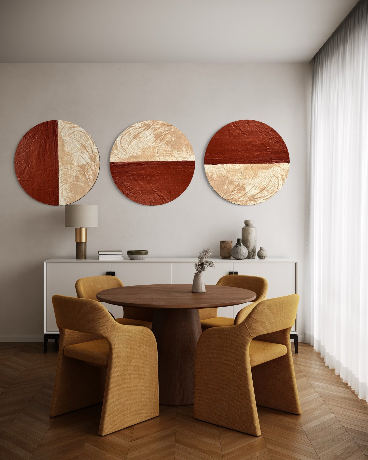 Dining room with a round wooden table and chairs, featuring abstract wall art.