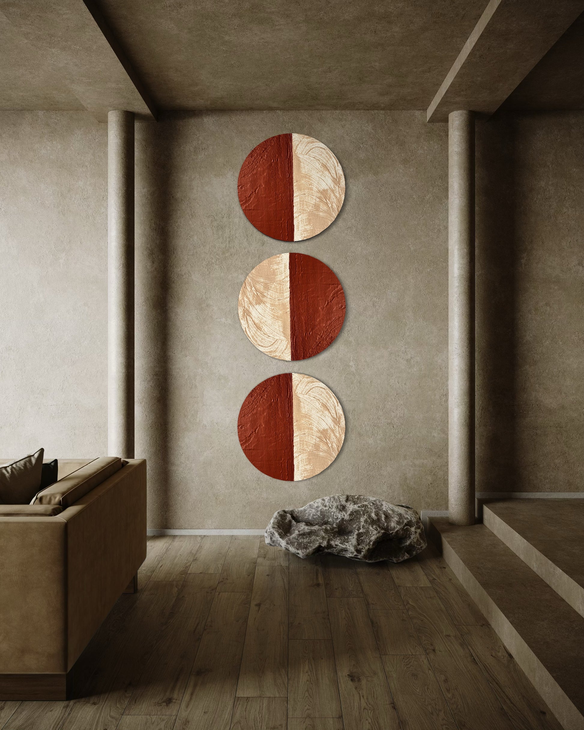 Three circular wall art pieces in red and beige on a gray wall in a modern room.