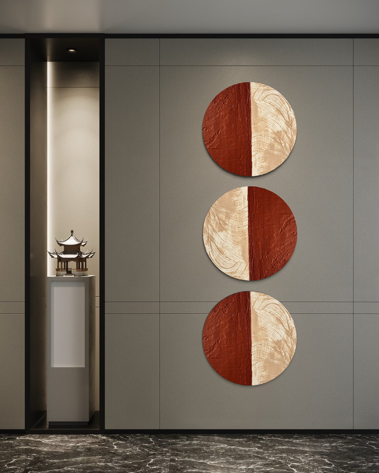 Three circular wall art pieces with a red and beige design on a gray wall.