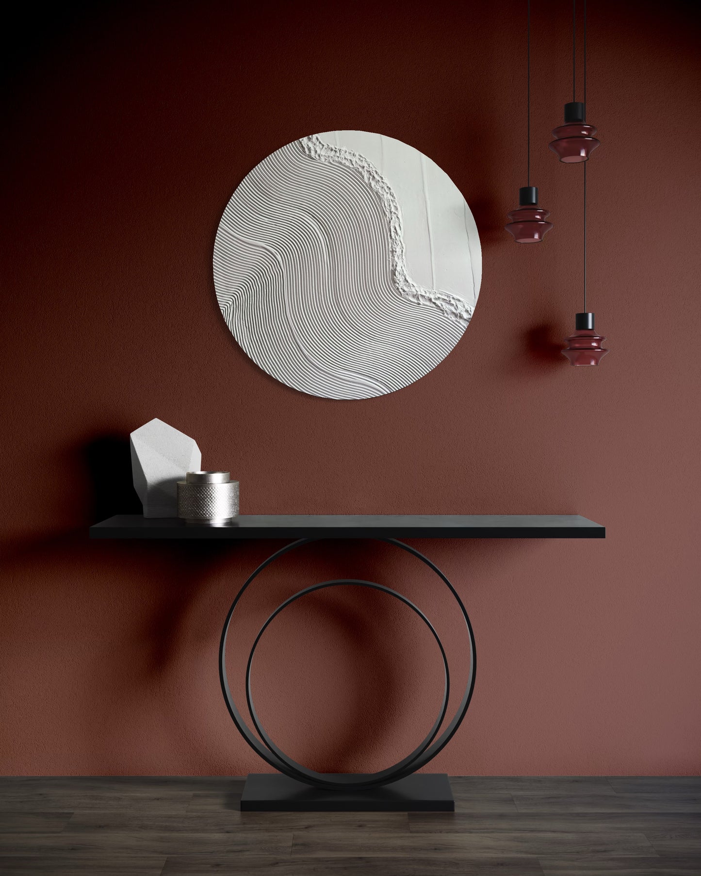 Round textured wall art piece on a brown wall with a black console table and decorative items.