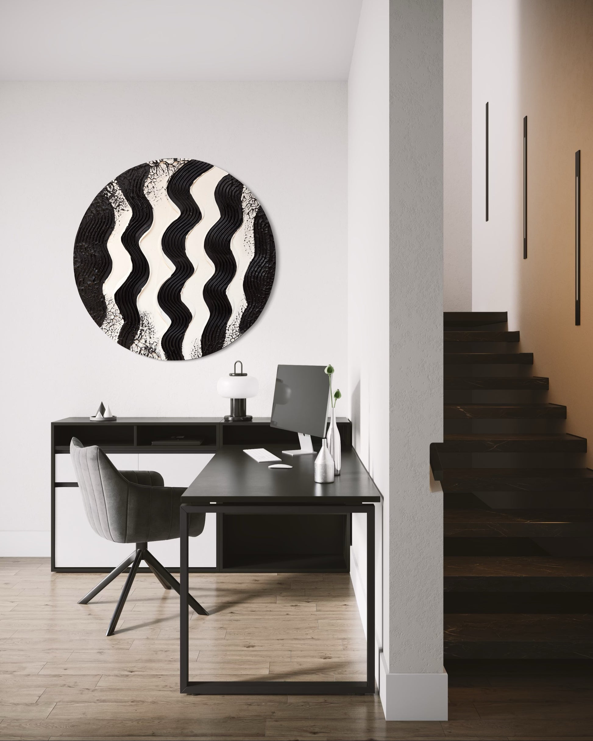 Modern interior with a black and white abstract wall art piece above a desk.