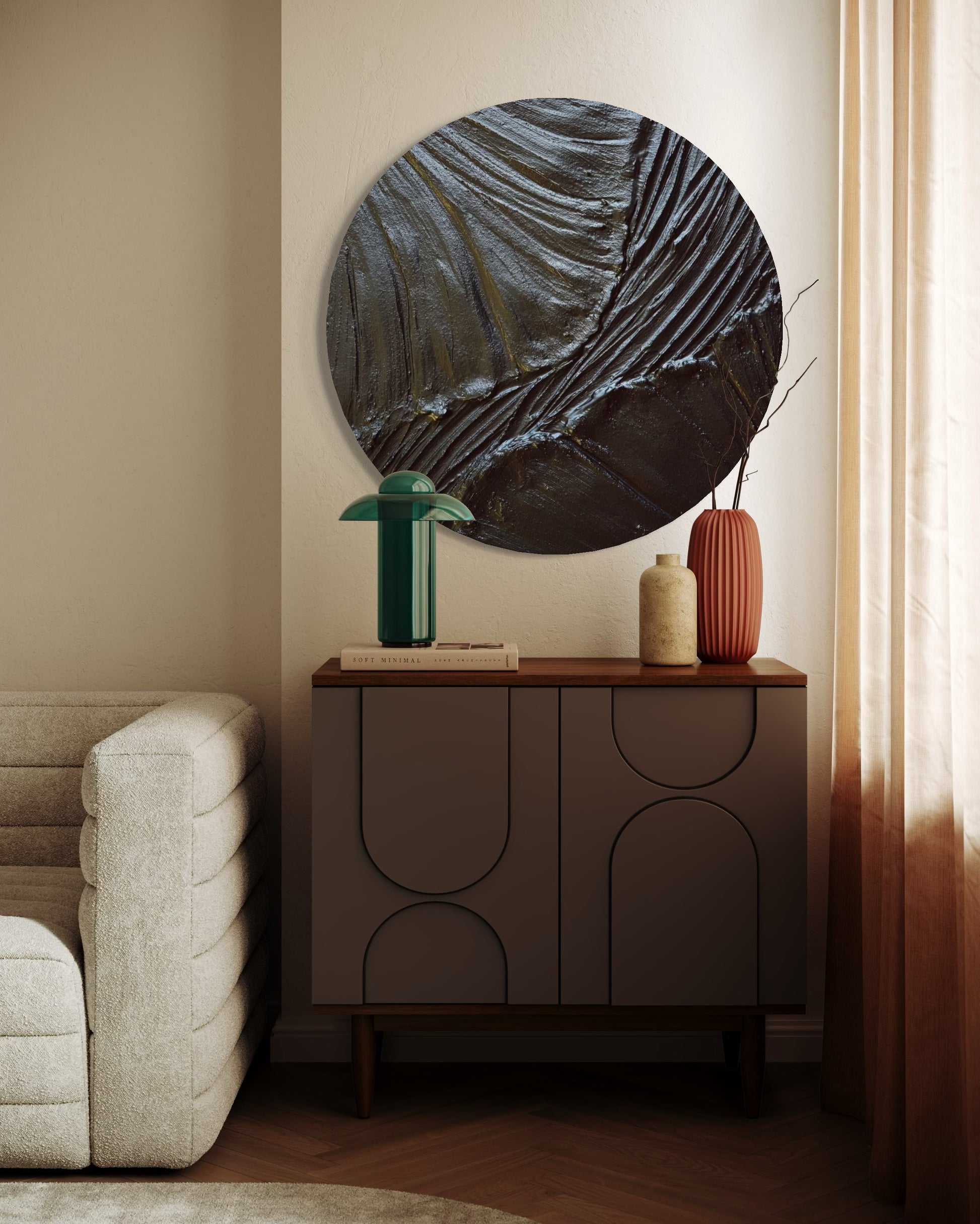Round abstract wall art above a wooden cabinet with decorative vases in a living room setting.