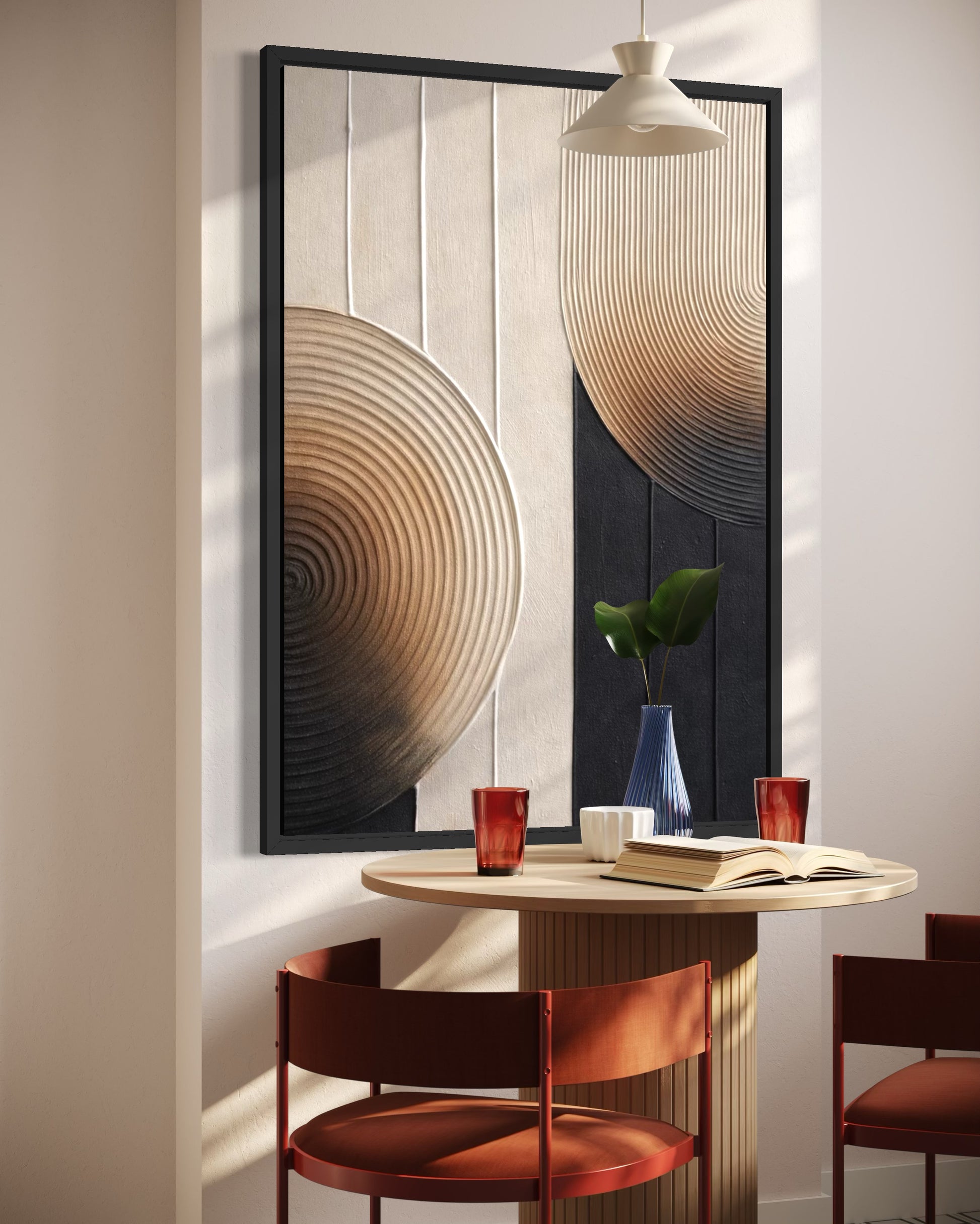 Modern interior with a round table and chairs, framed abstract art on the wall, and a vase with a plant.