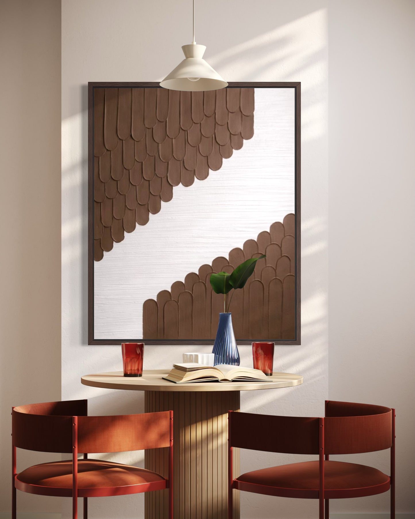 Dining area with a round table and red chairs, featuring a decorative mirror on the wall.