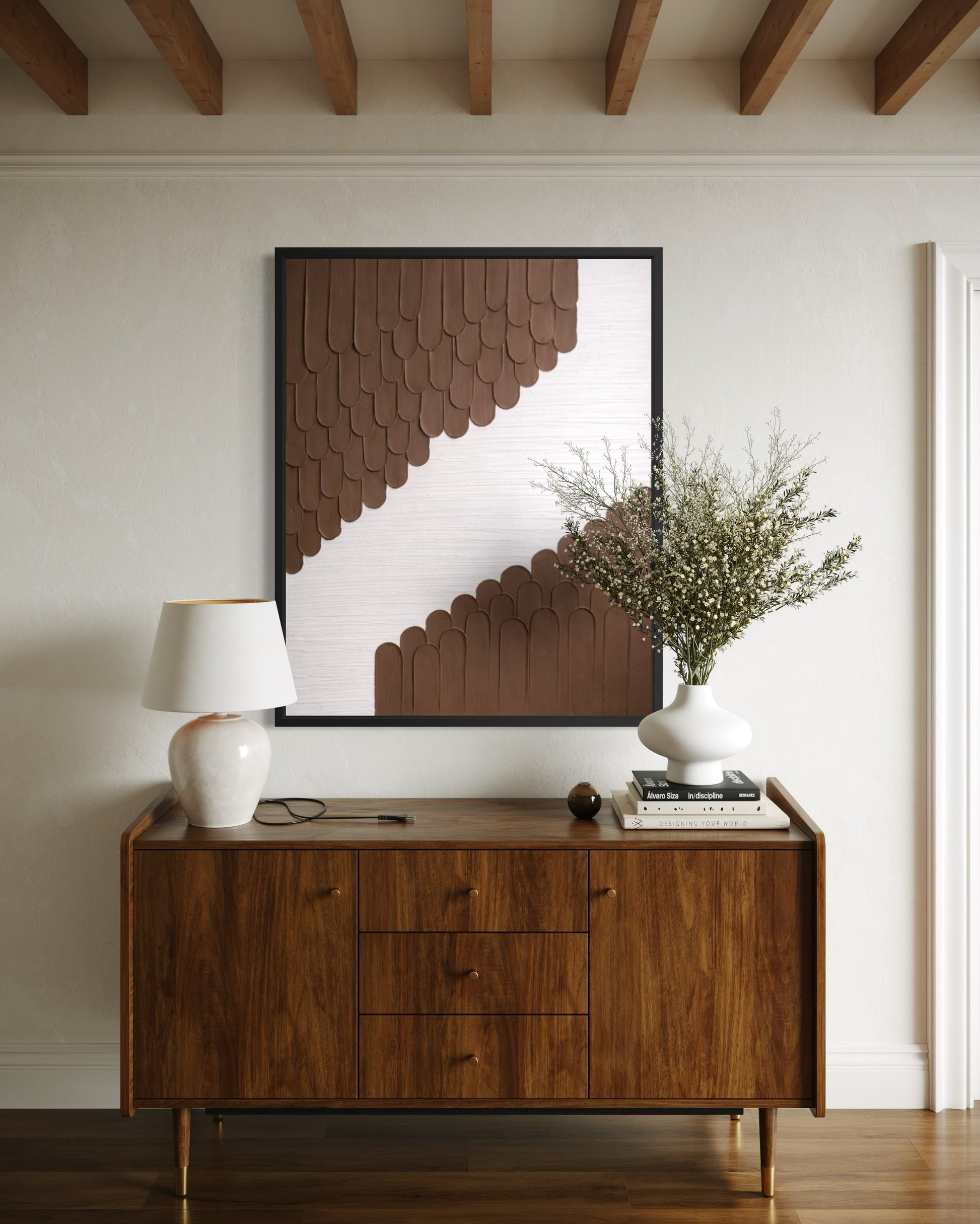 Wooden sideboard with decorative items in a room with wooden beams.