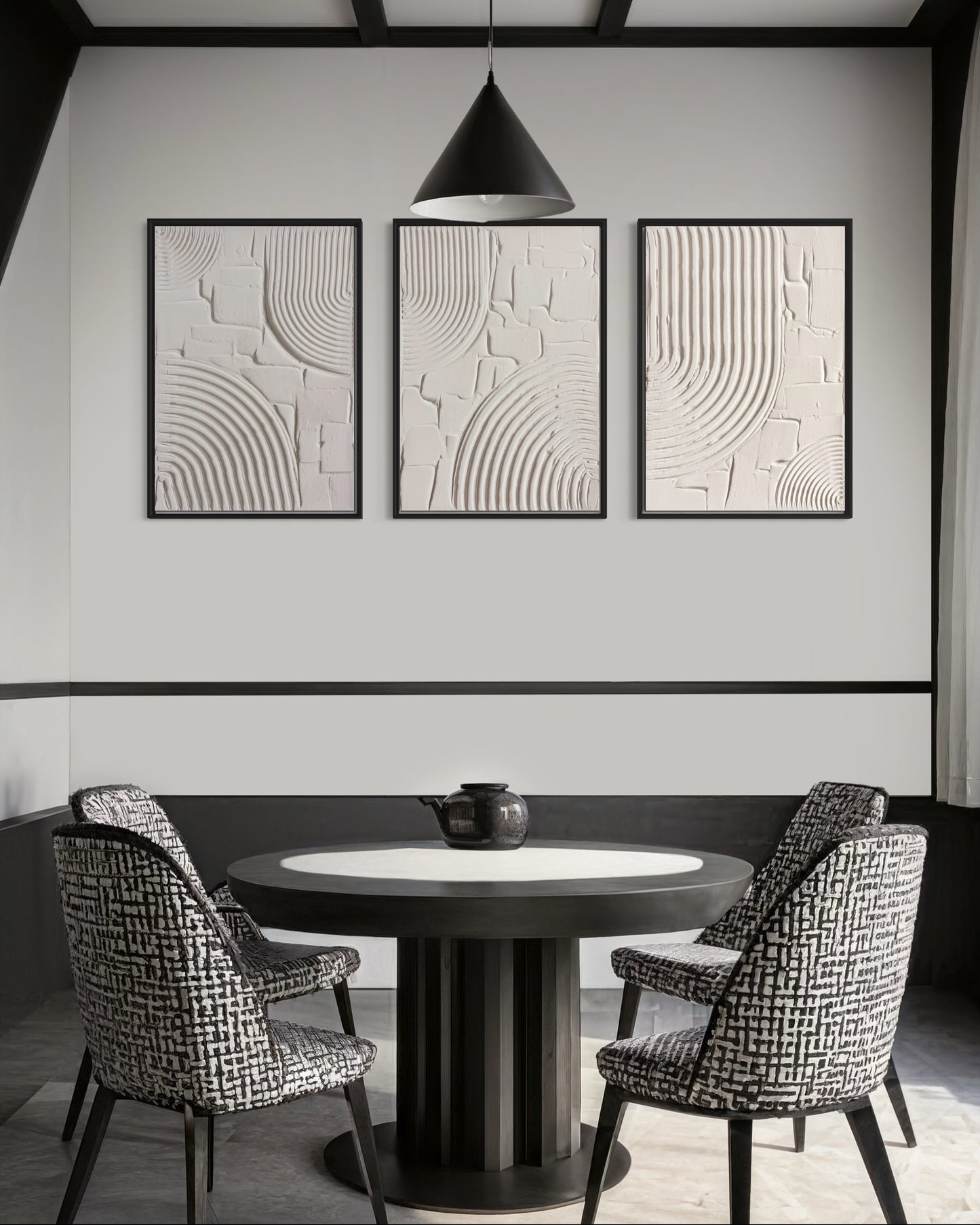 Dining room with round table and chairs, abstract wall art, and pendant light.