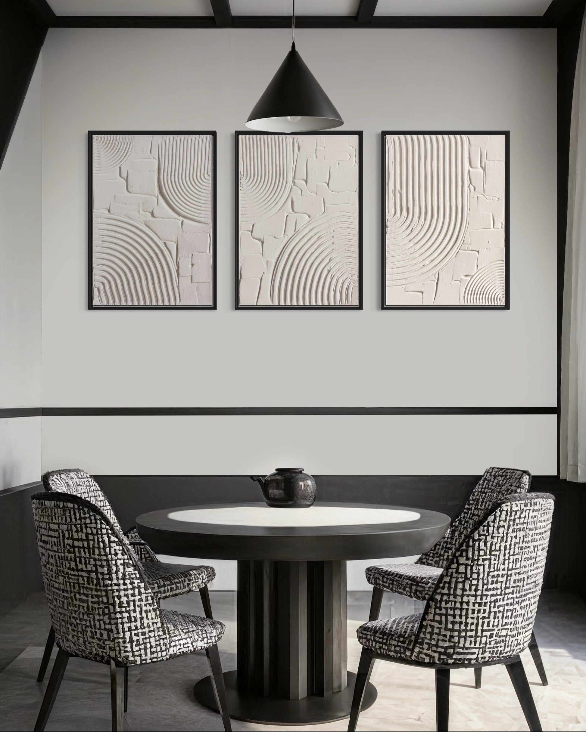 Dining room with round table and chairs, abstract wall art, and pendant light.
