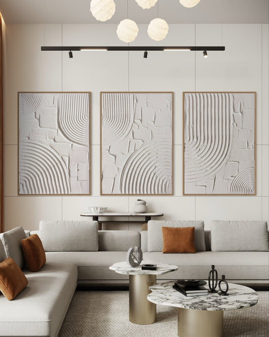Modern living room with a gray sofa, abstract wall art, and decorative coffee tables.
