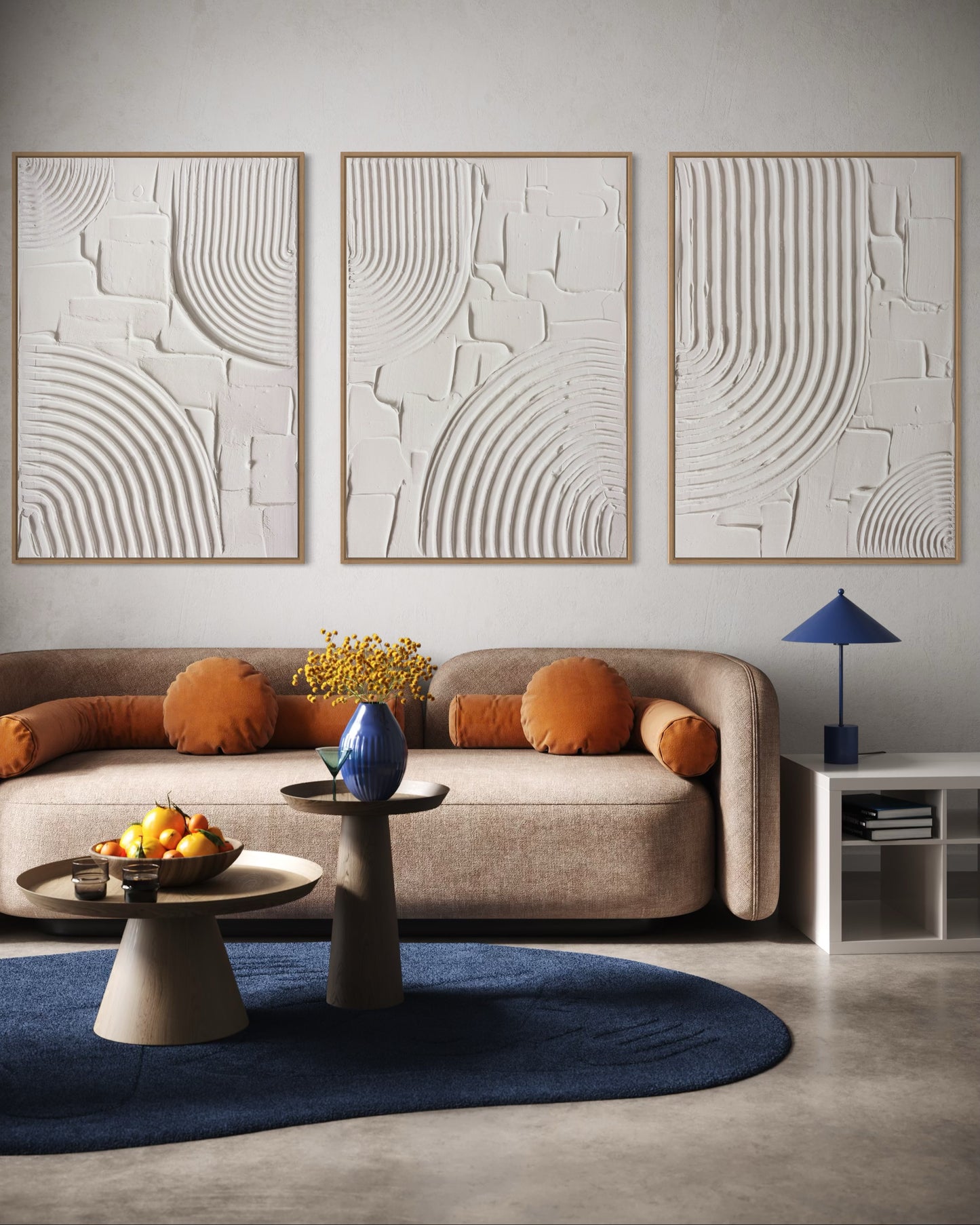 Modern living room with a beige sofa, abstract wall art, and decorative items.