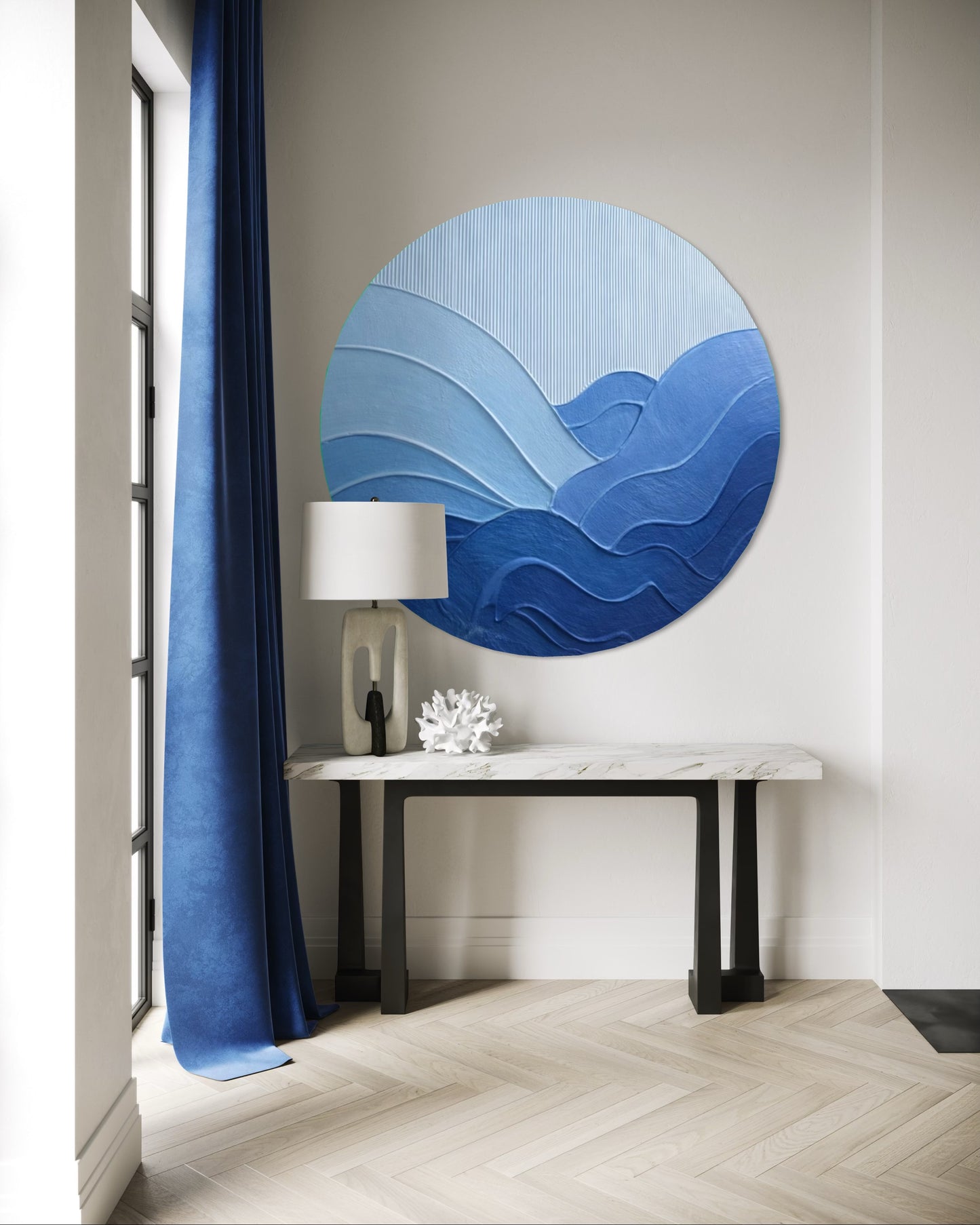 Modern interior with a round blue wall art piece, lamp, and decorative items.