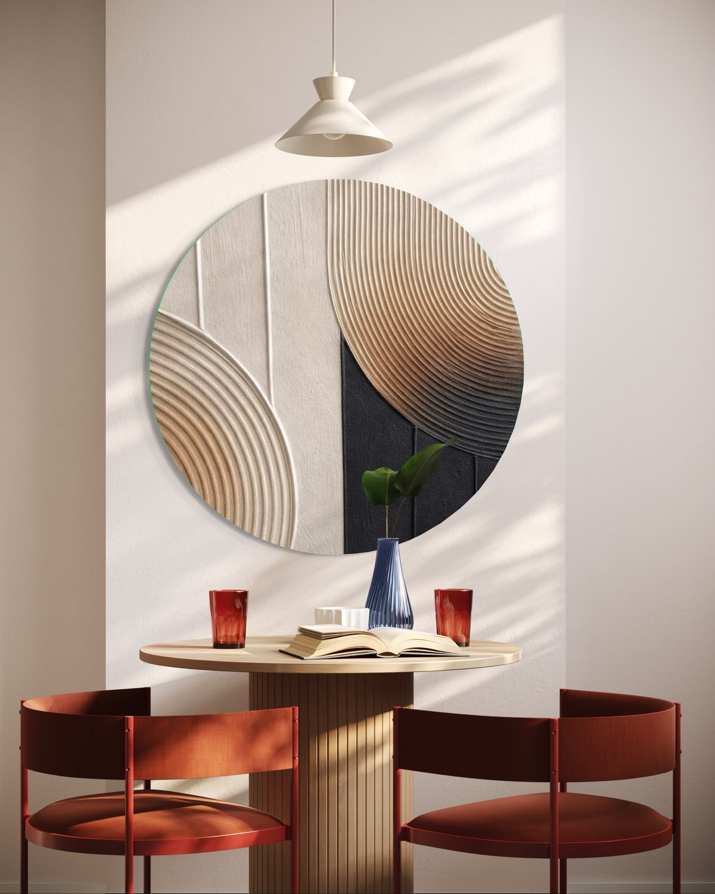Round decorative wall mirror with a modern design in a minimalistic room.