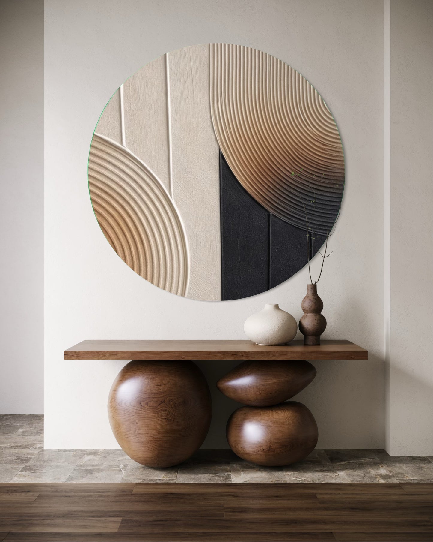 Round abstract wall art piece in a room with a wooden console table and decorative items.