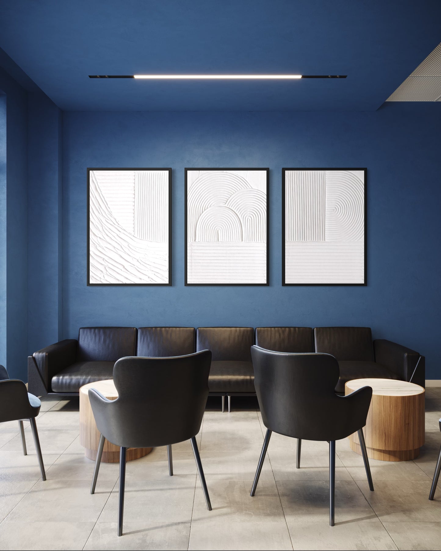 Modern waiting room with blue walls, black chairs, and abstract art.