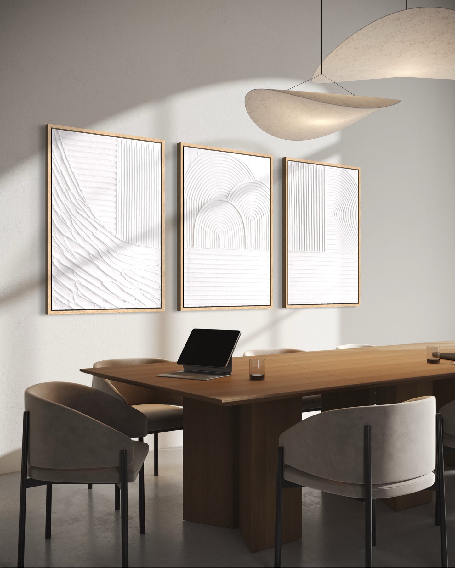 Modern office setting with a wooden desk, chairs, and abstract wall art.